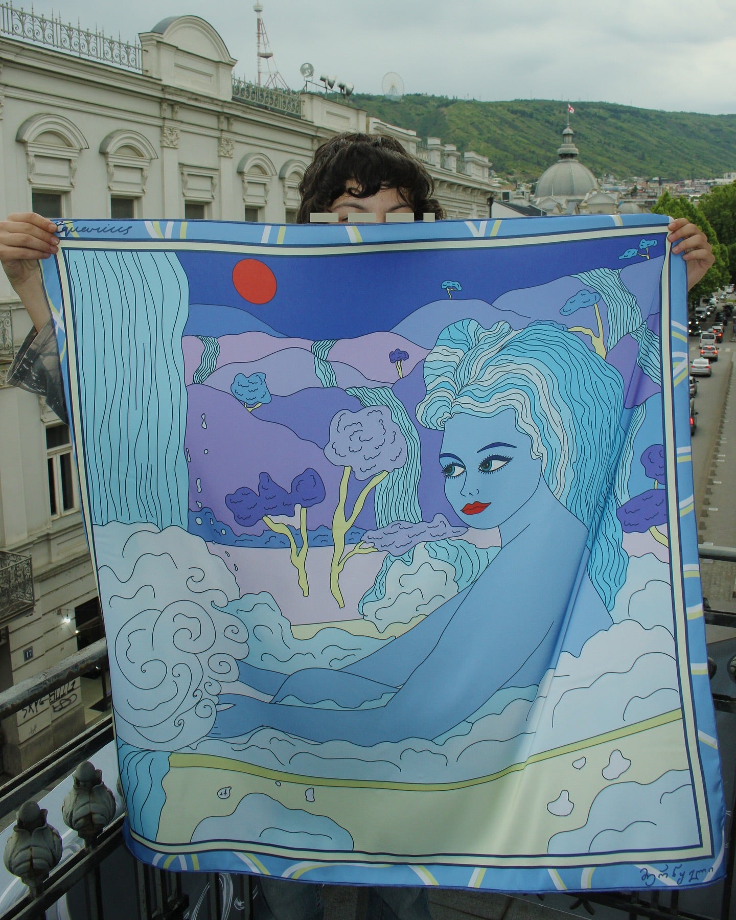 A person holding up a blue silk scarf with a colorful character illustration by Anano Kevanishvili, Aquarius by DAE