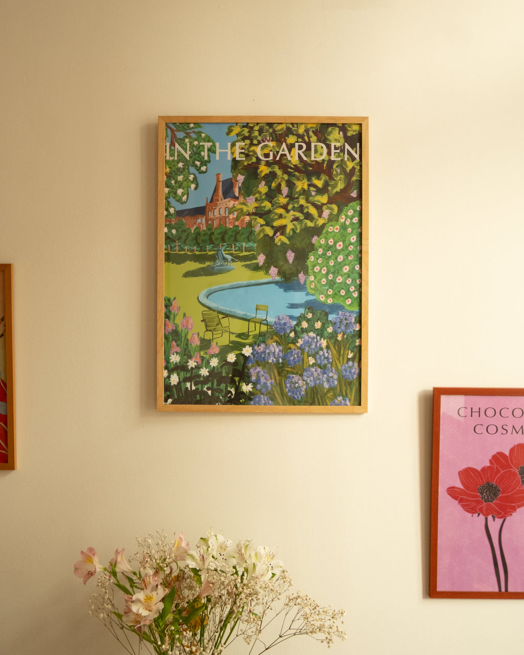 Poster "In the Garden" on the white wall