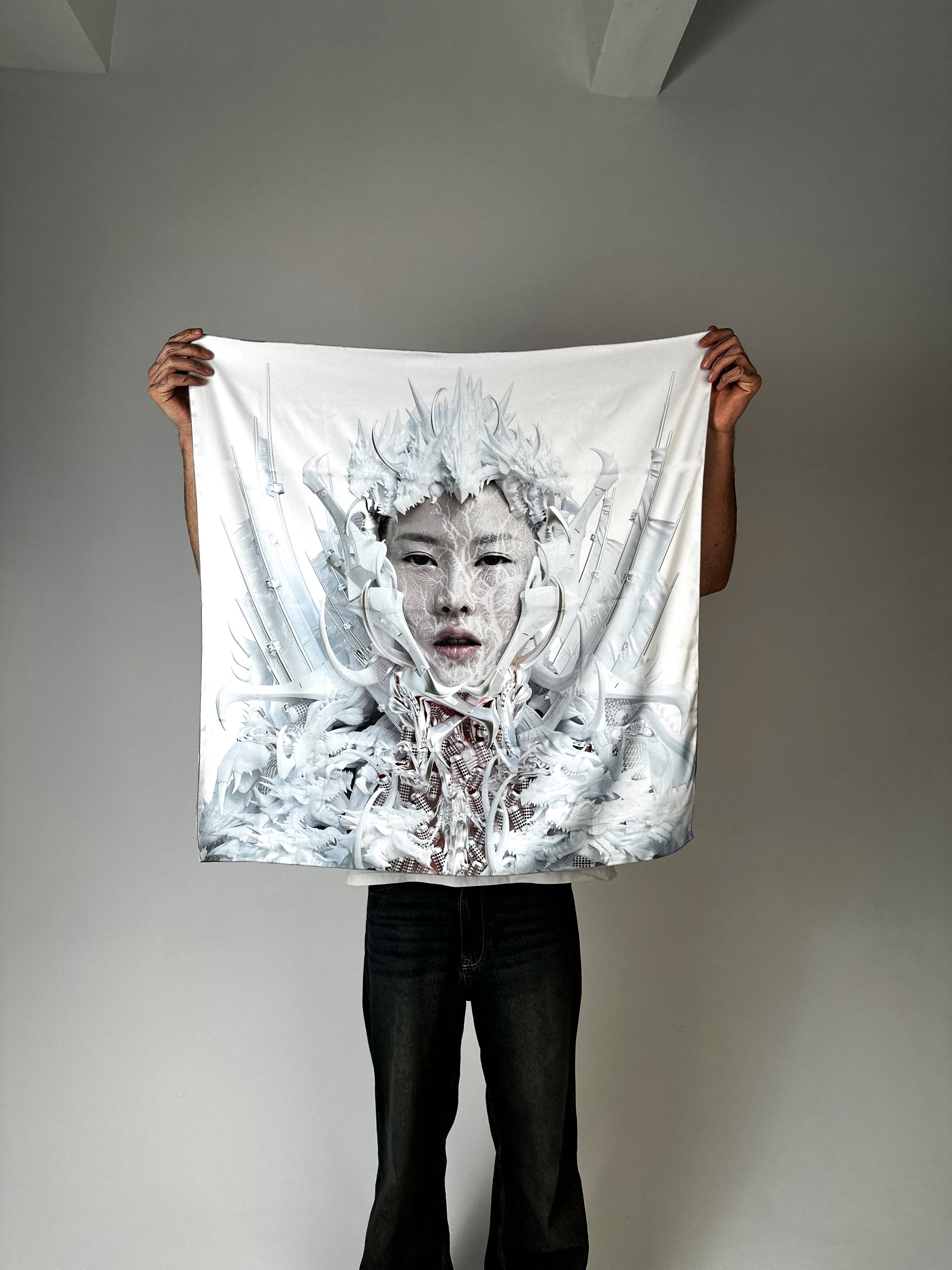 Person holding Tamar Mepe art silk scarf illustrated by Japari in white and icy blue tones