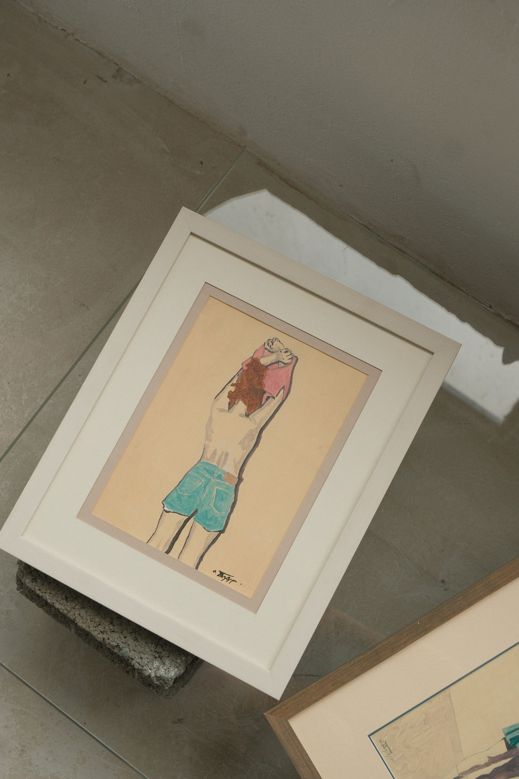 Framed artwork on a concrete floor