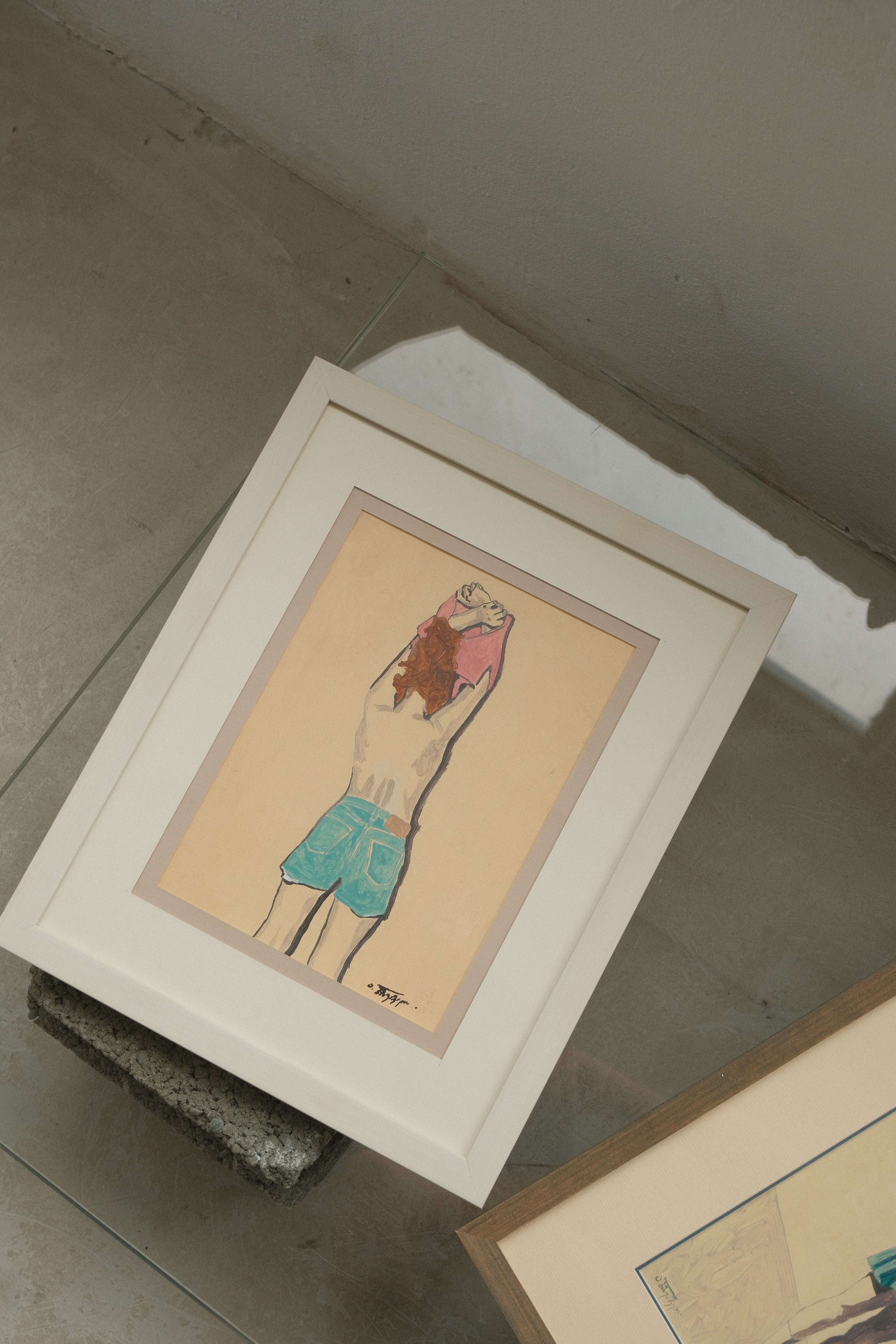 Framed artwork on a concrete floor