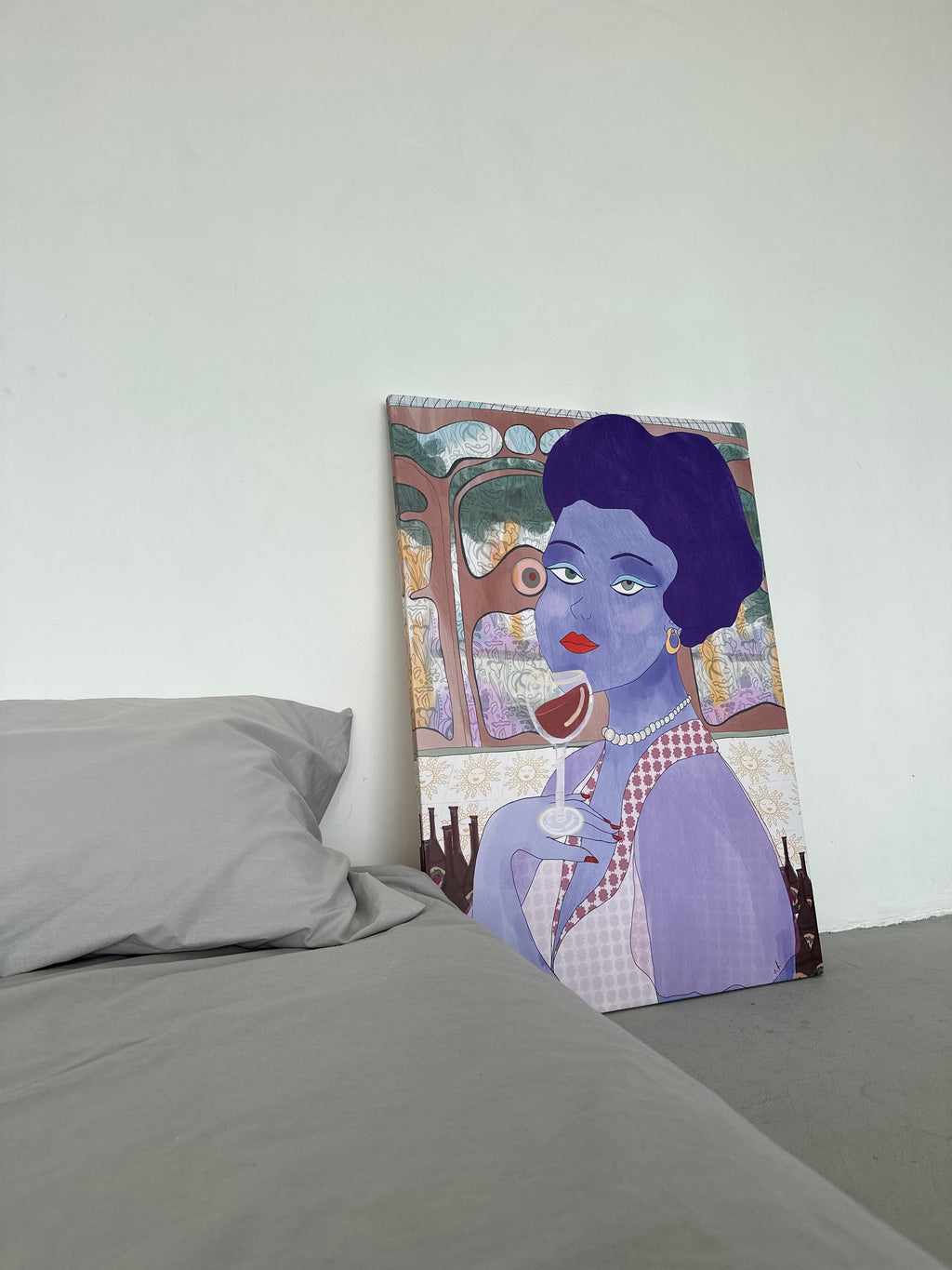 Canvas print of a stylized portrait on a bed with gray bedding.