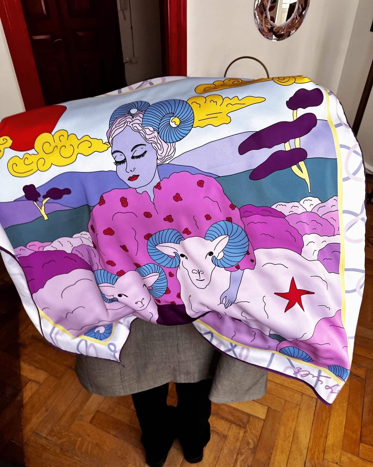 Close-up of Aries zodiac art silk scarf with vibrant colors and symbolic elements