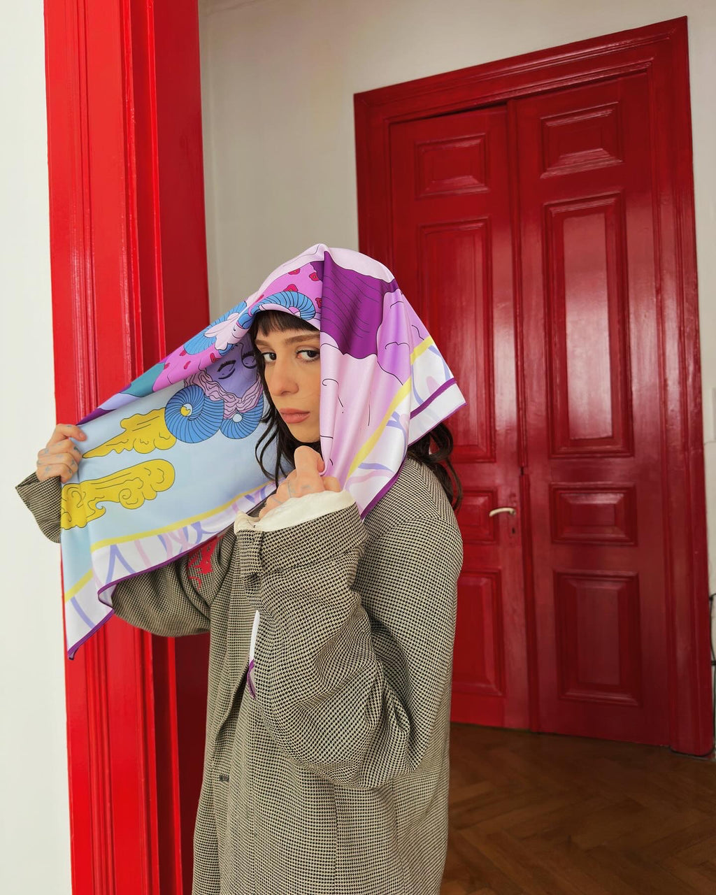 Model wearing Aries zodiac illustrated scarf by Georgian artist Anano Kevanishvili