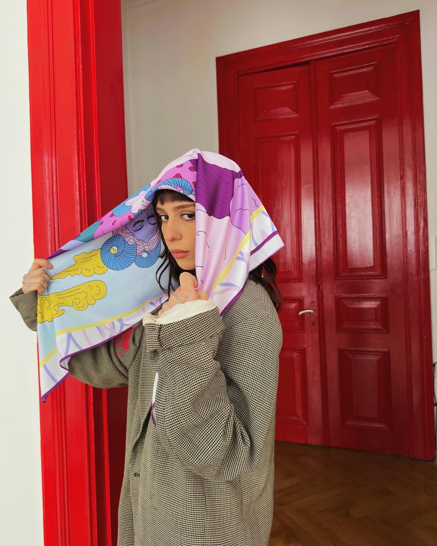 Model wearing Aries zodiac illustrated scarf by Georgian artist Anano Kevanishvili