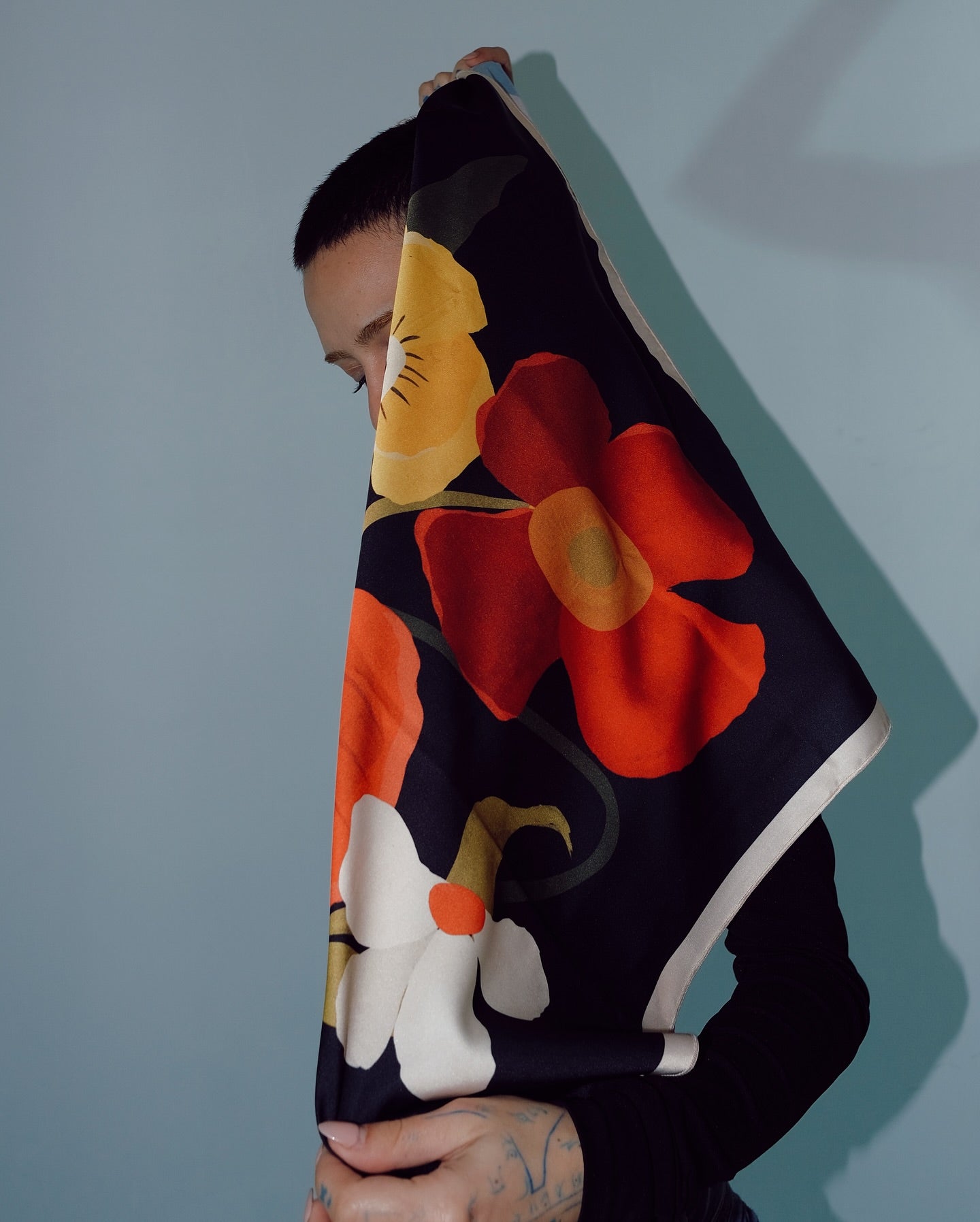 Lea Woo illustrated scarf with orange tones and floral details