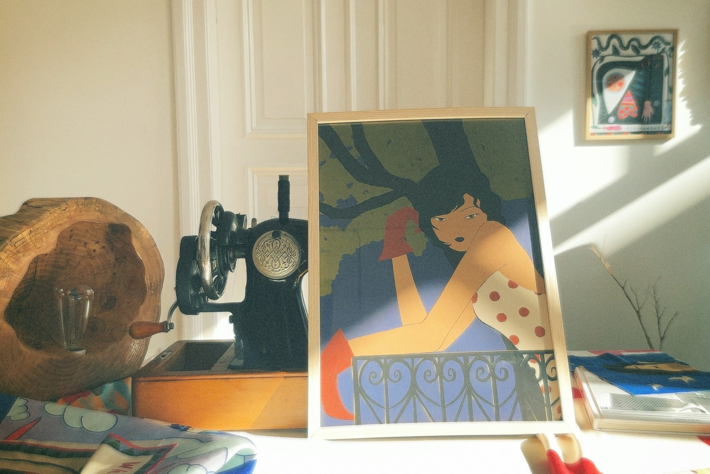 A poster featuring an illustration by Lea Woo, depicting a woman on a balcony, with a vintage sewing machine and decorative items in the background.