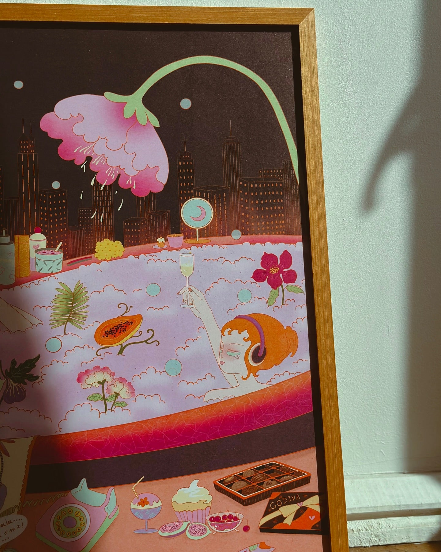 girl laying in bathtub with champagne flowers fruit view of city, framed in wood