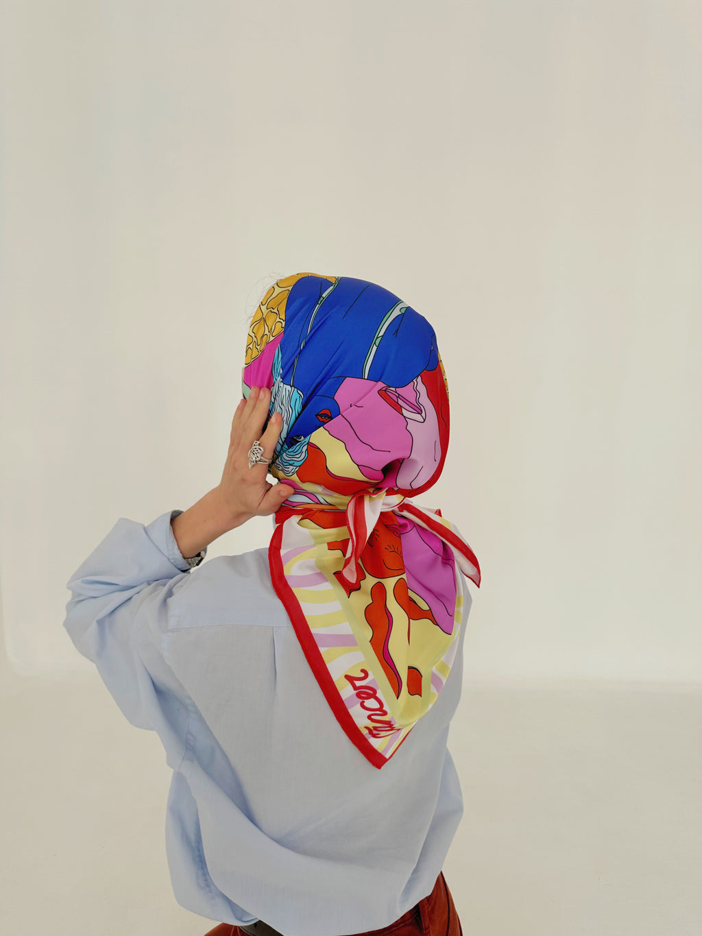 Model presenting Cancer zodiac illustrated scarf with vibrant symbolic design