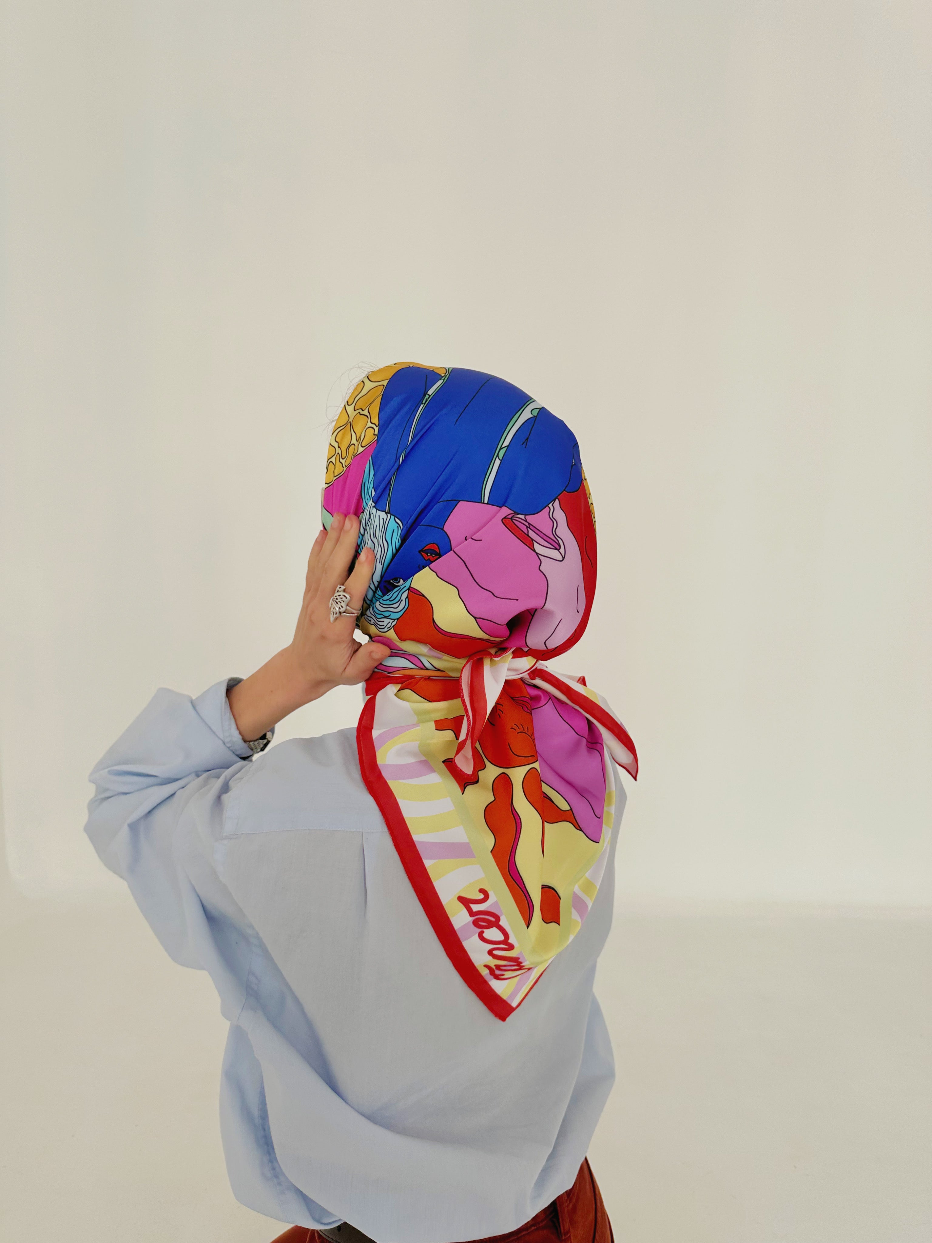 Model presenting Cancer zodiac illustrated scarf with vibrant symbolic design