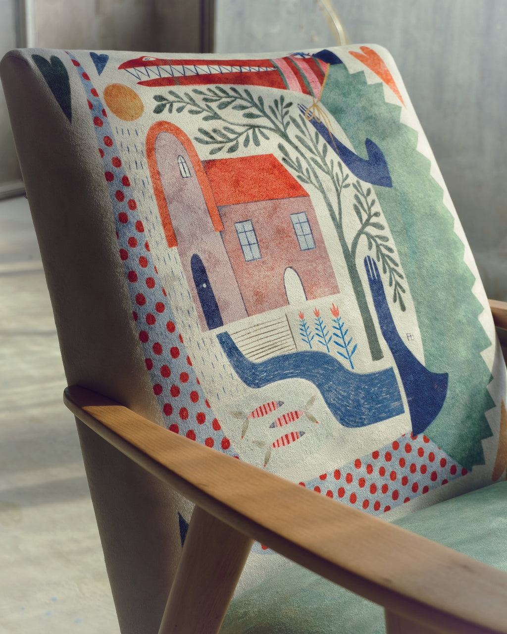 Decorative chair with a house and nature design on a wooden chair.