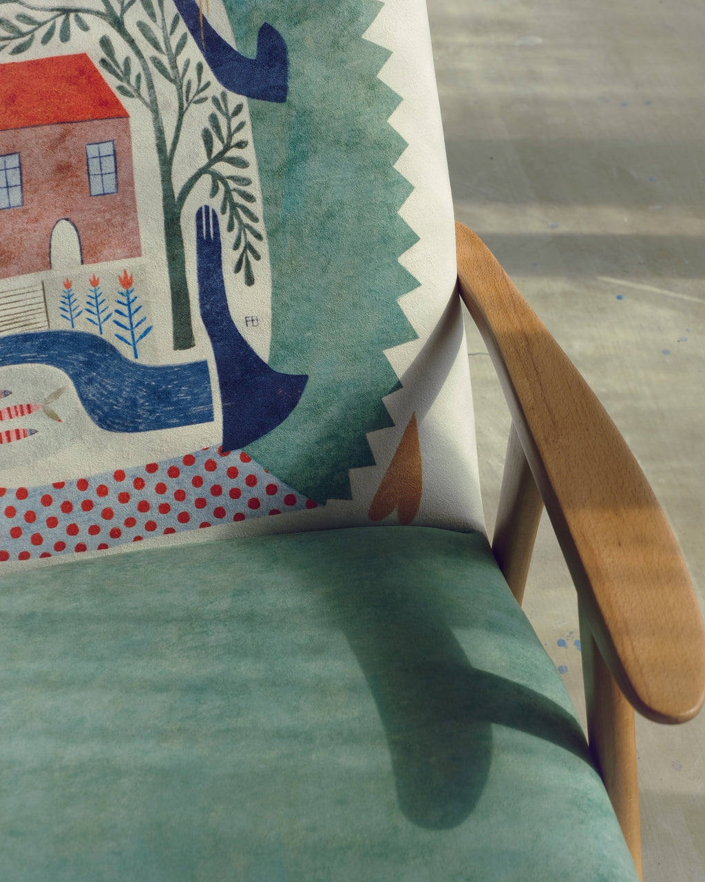 Chair with a colorful illustrations featuring a house, tree, and boat design.