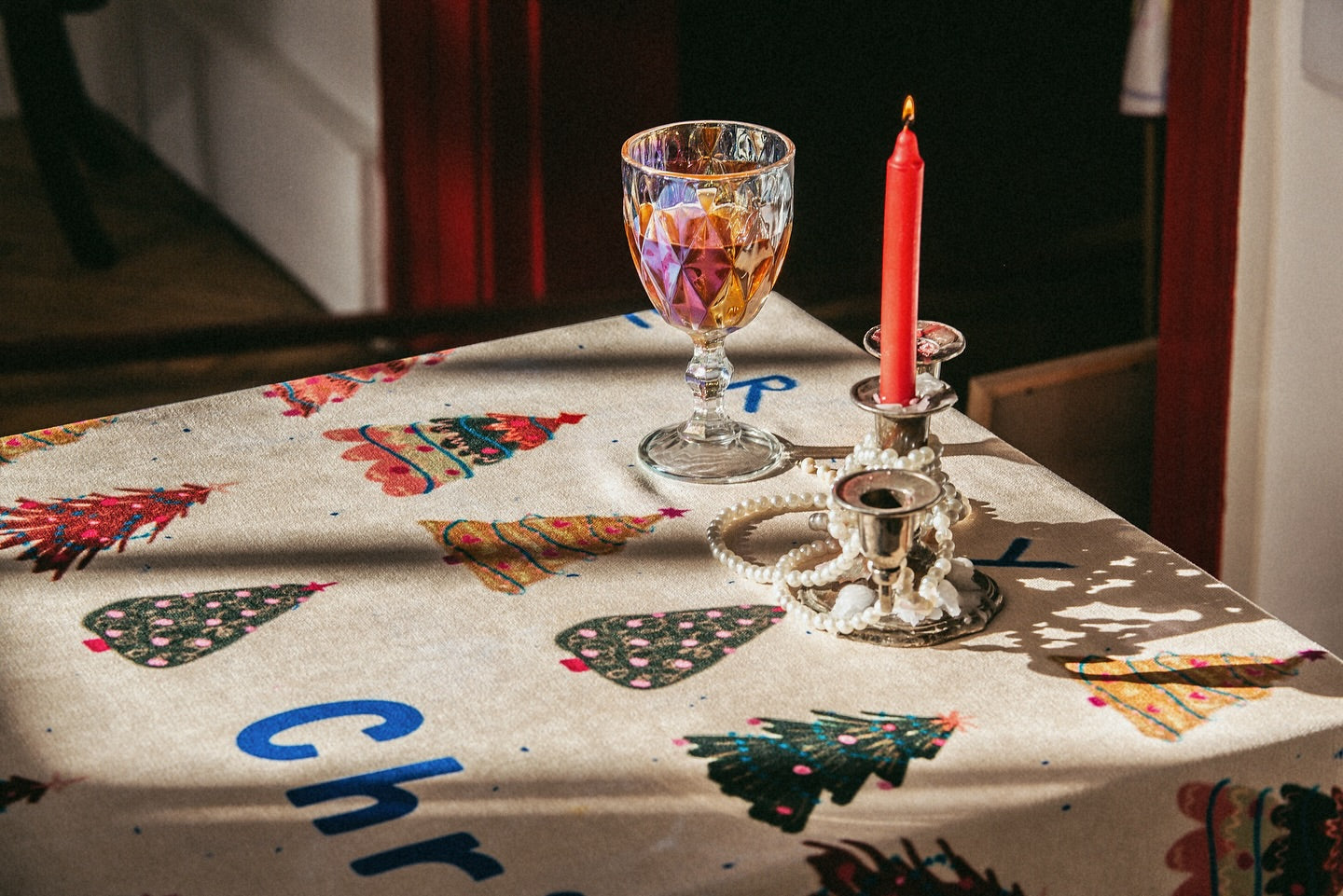 Close-up of Christmas tablecloth showing detailed festive illustrations