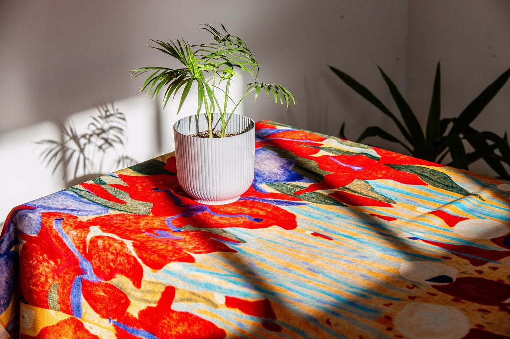 Spring Forest tablecloth folded on a white surface – vibrant floral illustration by Anano Kevanishvili