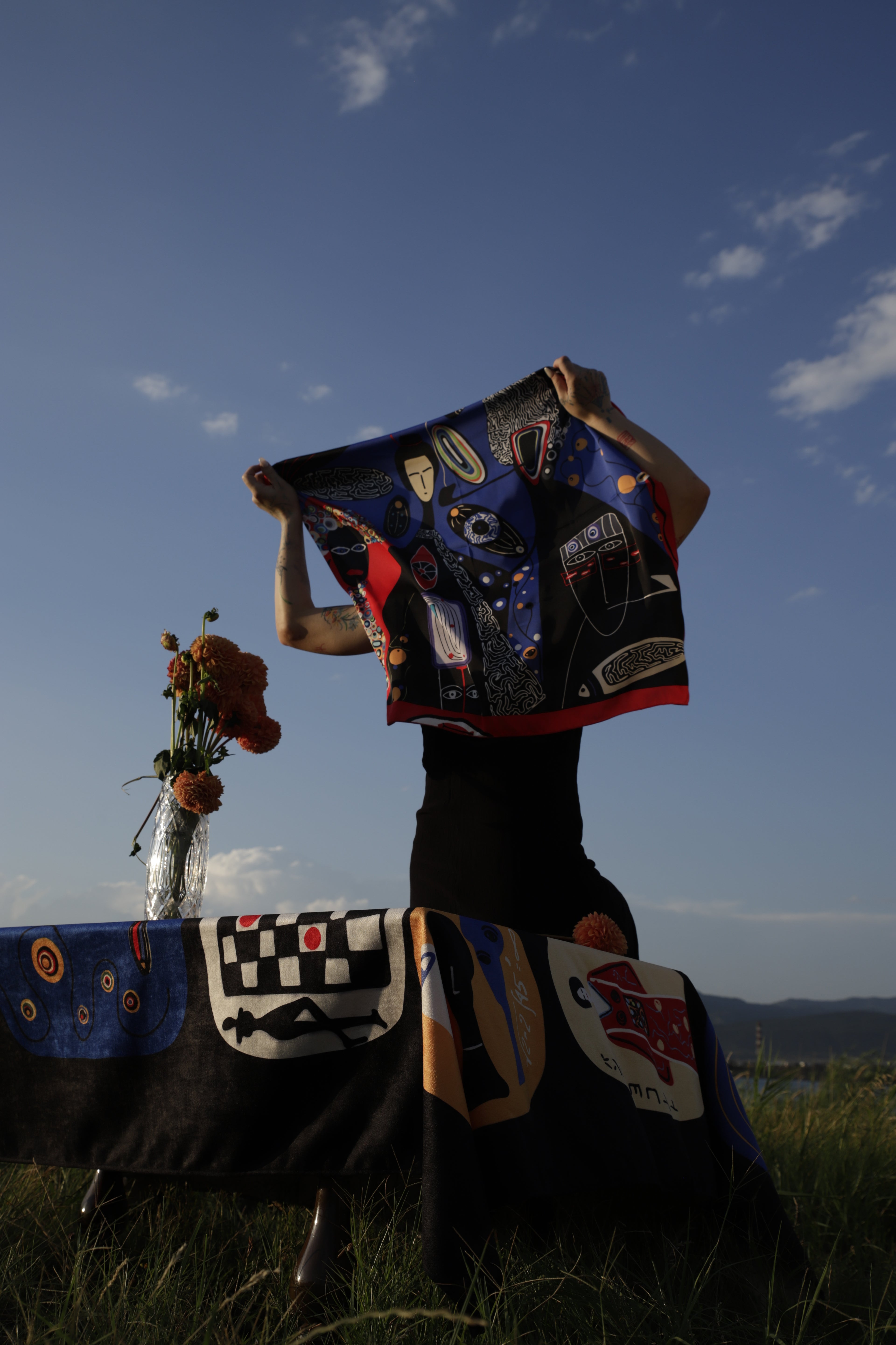 Printed scarf by Nino Bakuradze with vibrant character artwork