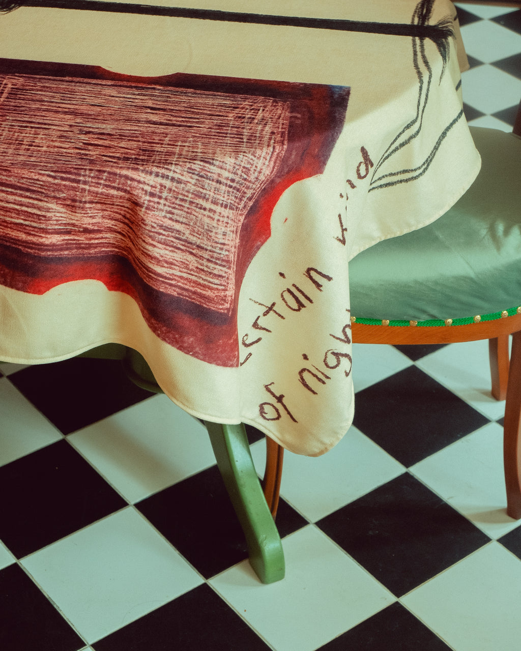 Chair with a DAE's Tablecloth on a checkered floor