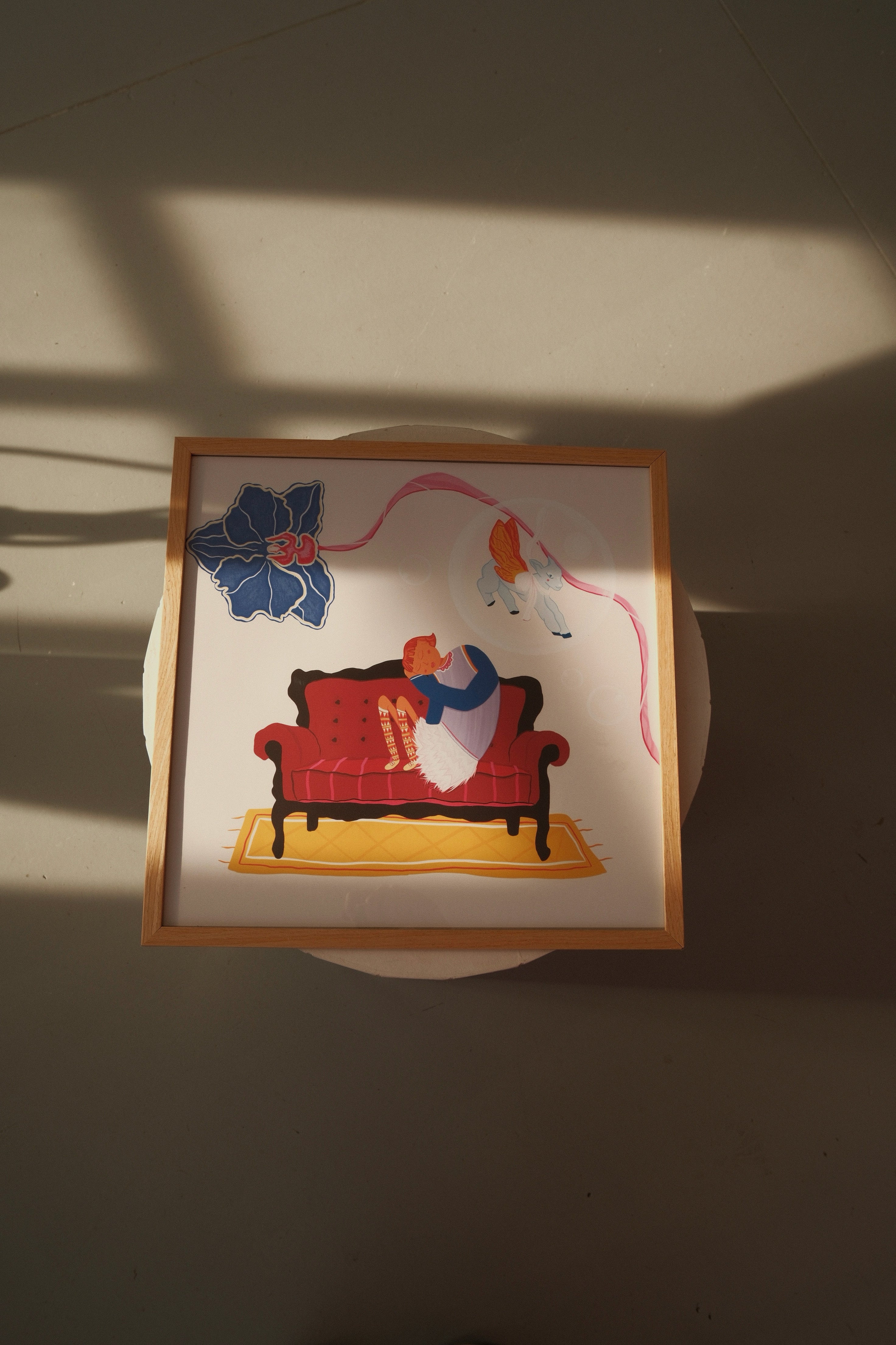 Dreamlike art poster “Reverie” by Tekle Ghvania. Surreal illustration with reclining woman, ribbon & symbolic elements. Contemporary wall art by DAE.