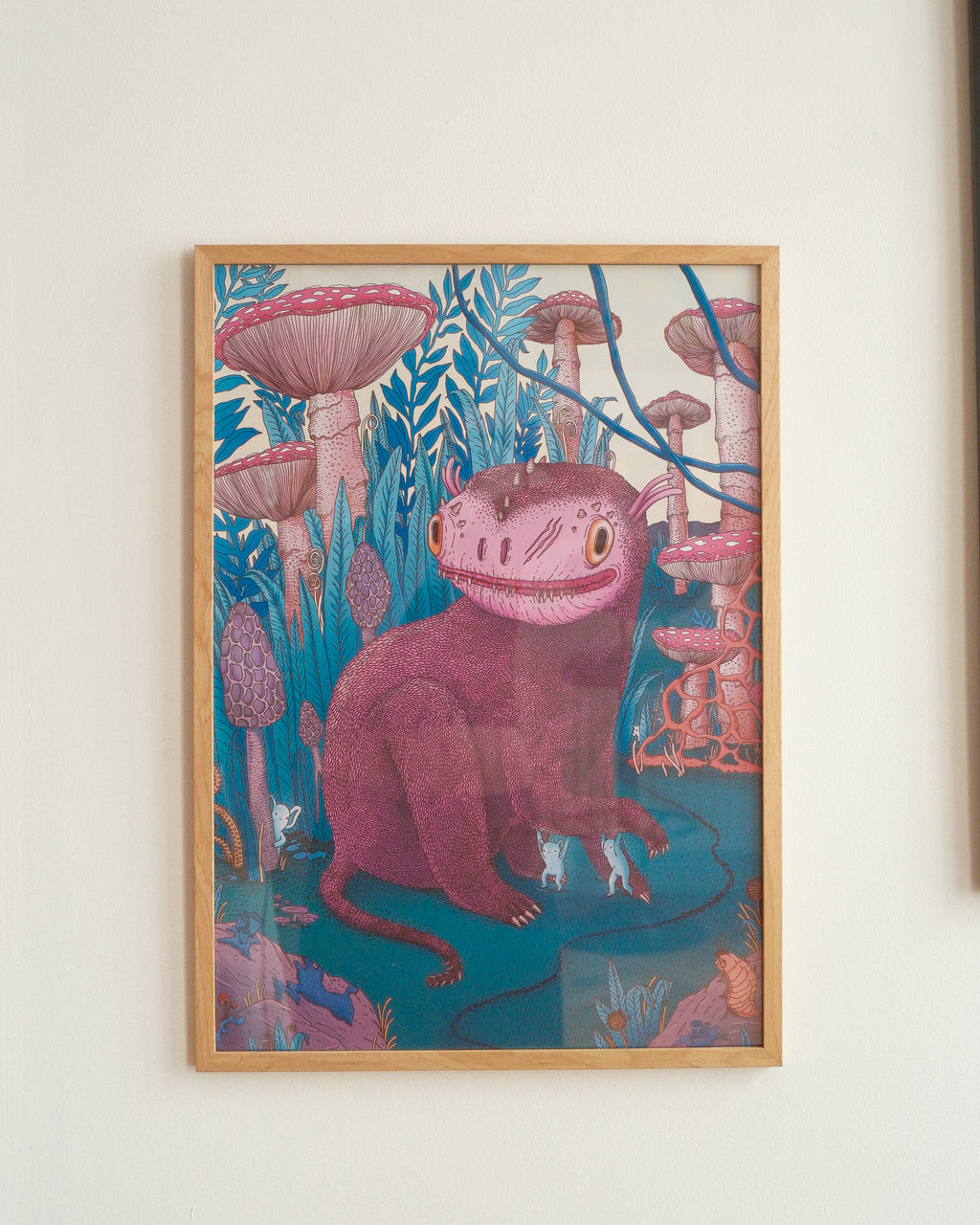 Framed artwork of a creature with a mushroom helmet in a forest setting