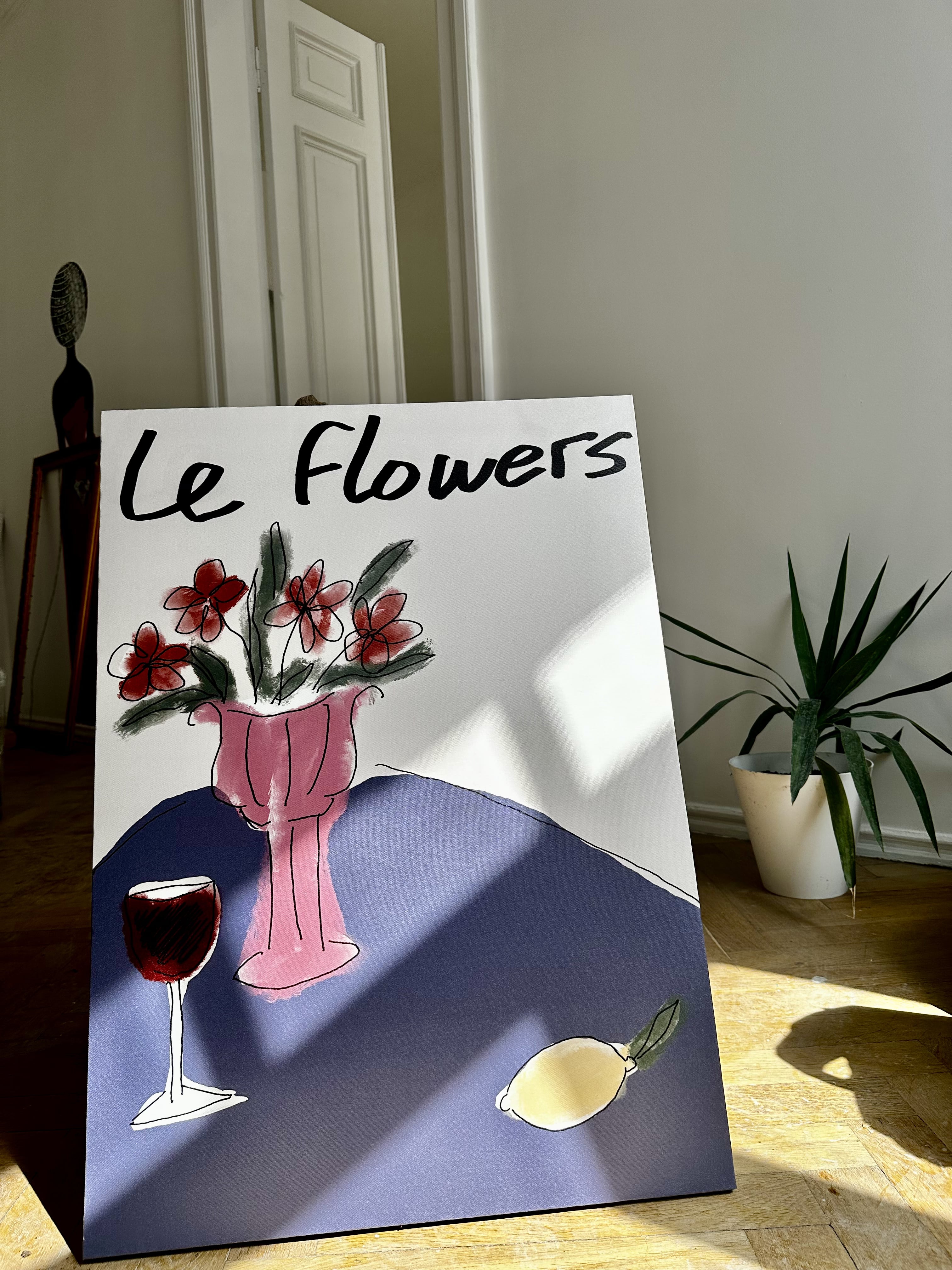 A painting titled 'Le Flowers' featuring a vase with flowers and a glass of wine on a table, with a bold signature at the bottom right.