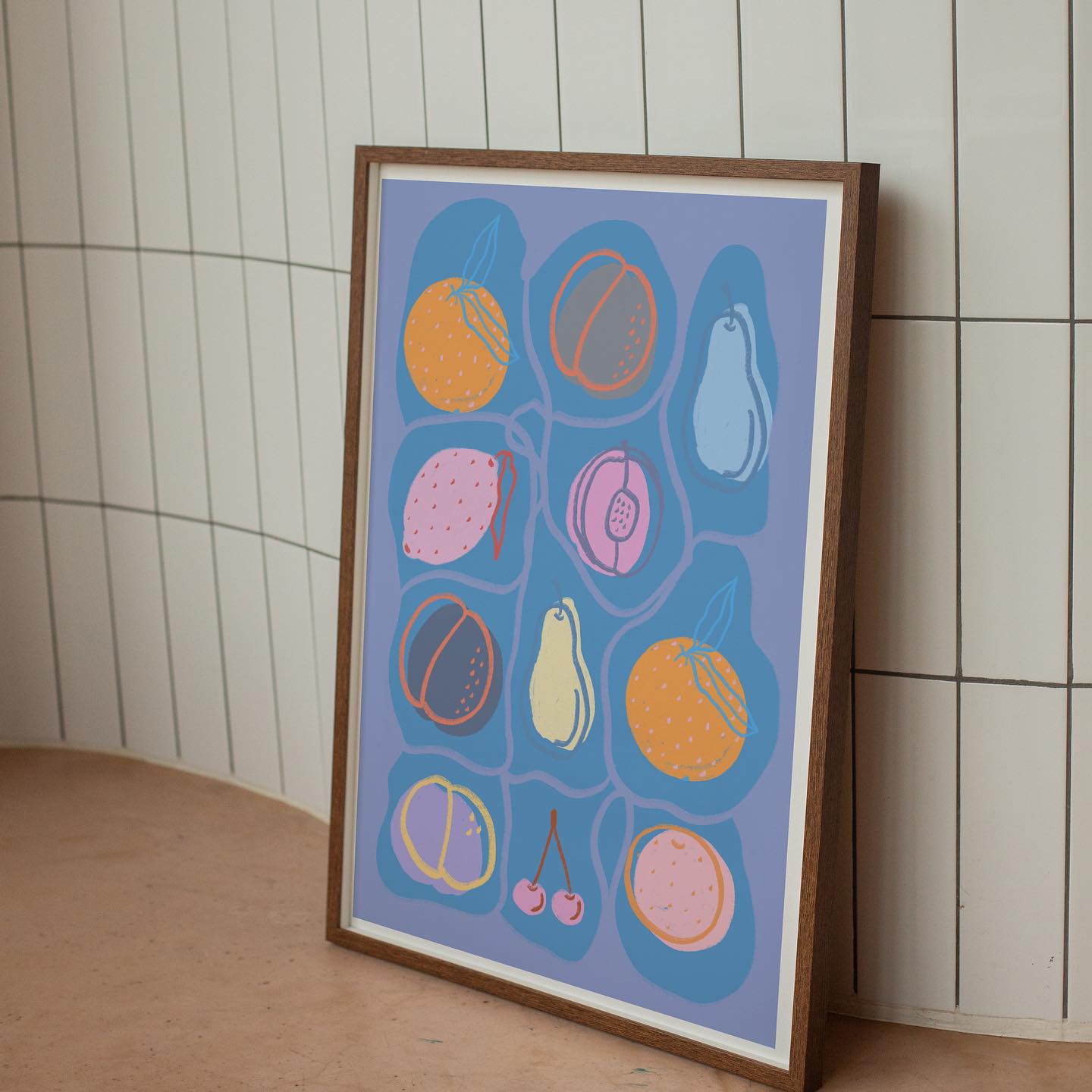 Framed artwork with colorful abstract design on a tiled wall.