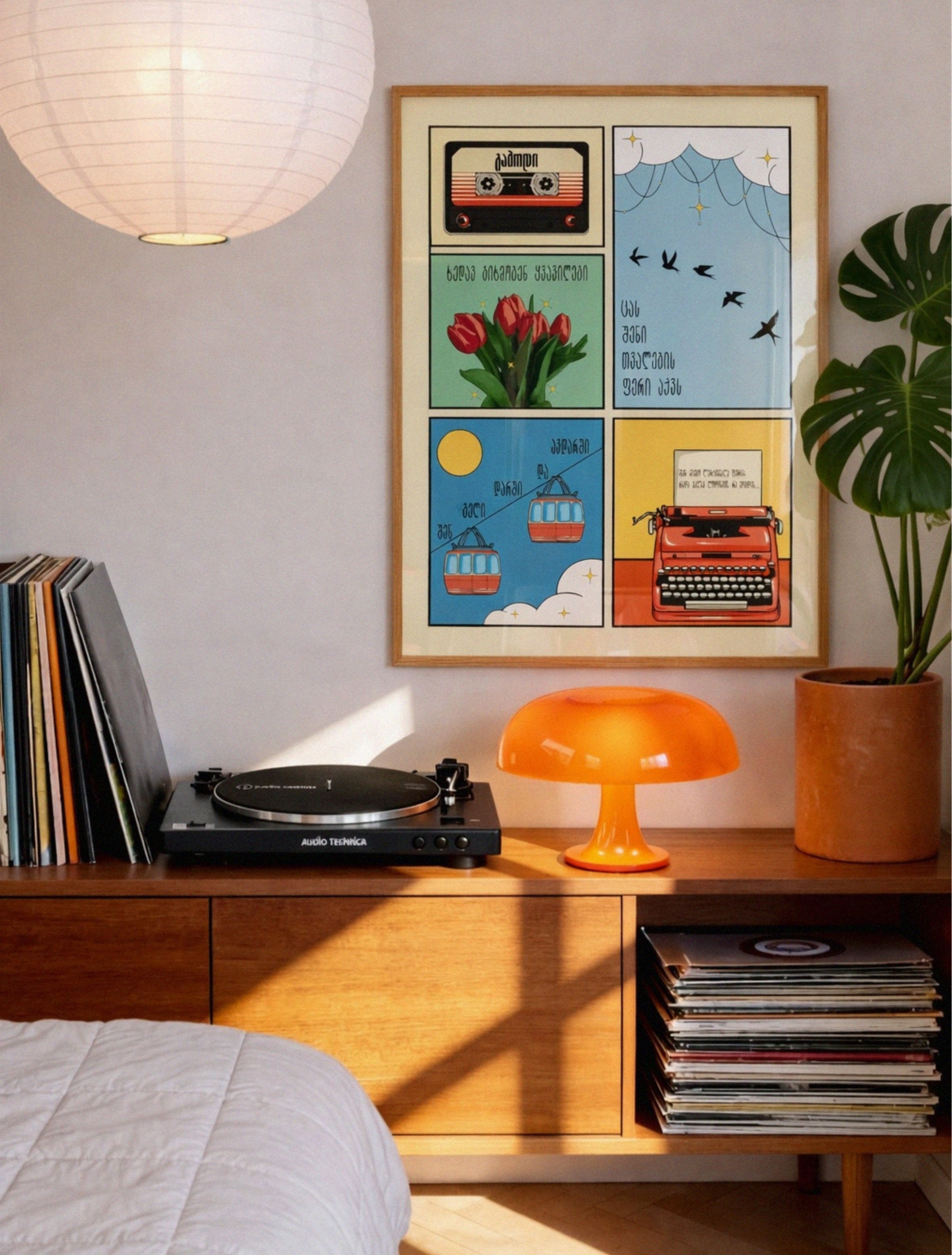 Room interior with a record player, colorful framed poster, and decorative items.