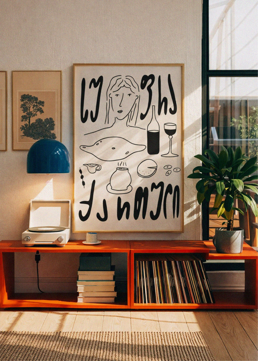 Modern living room with orange shelf, framed artwork, and decorative items.