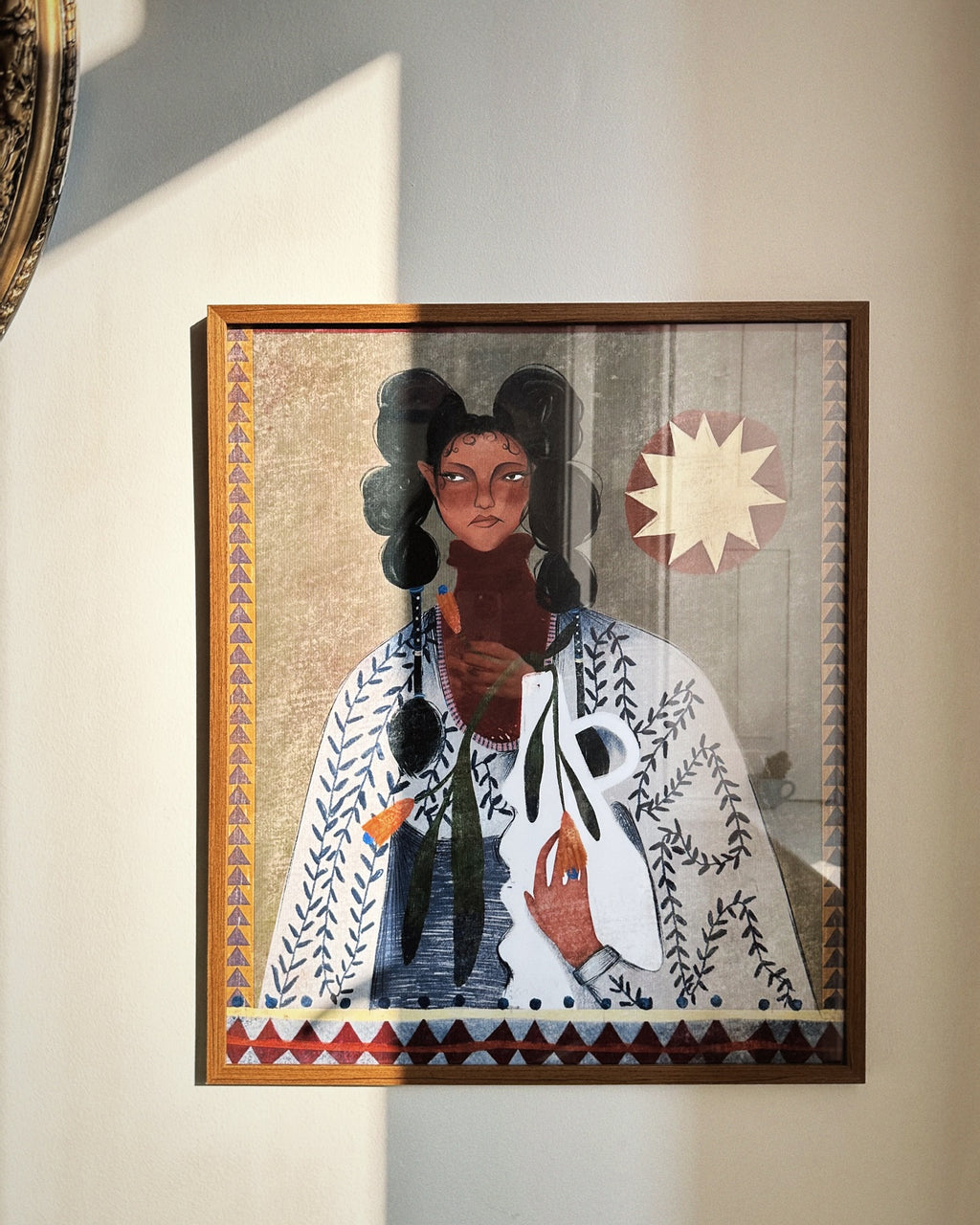 A poster featuring an illustration of a person with a geometric patterned garment and accessories, with a decorative border.