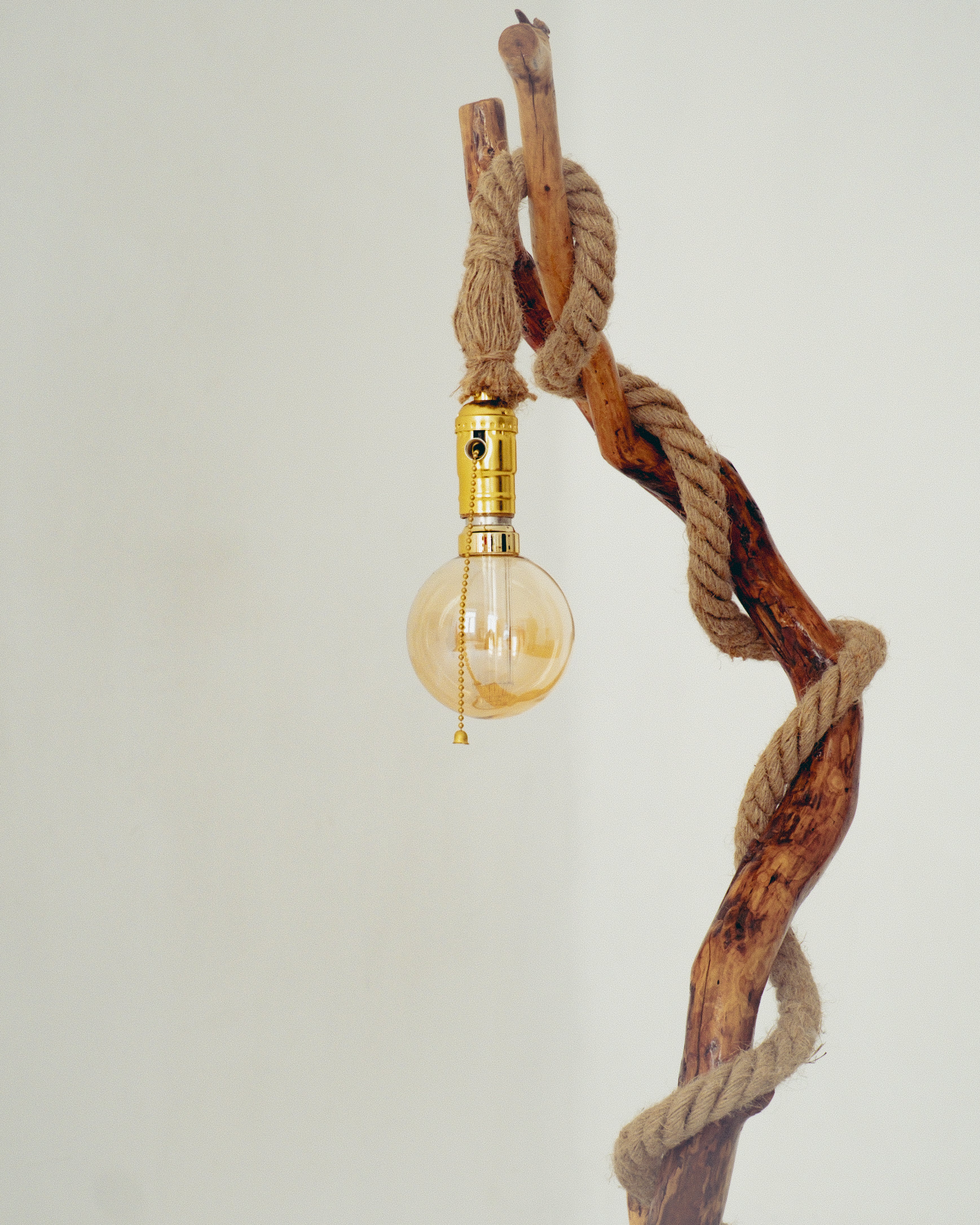 Decorative light fixture with a twisted rope design on a plain background