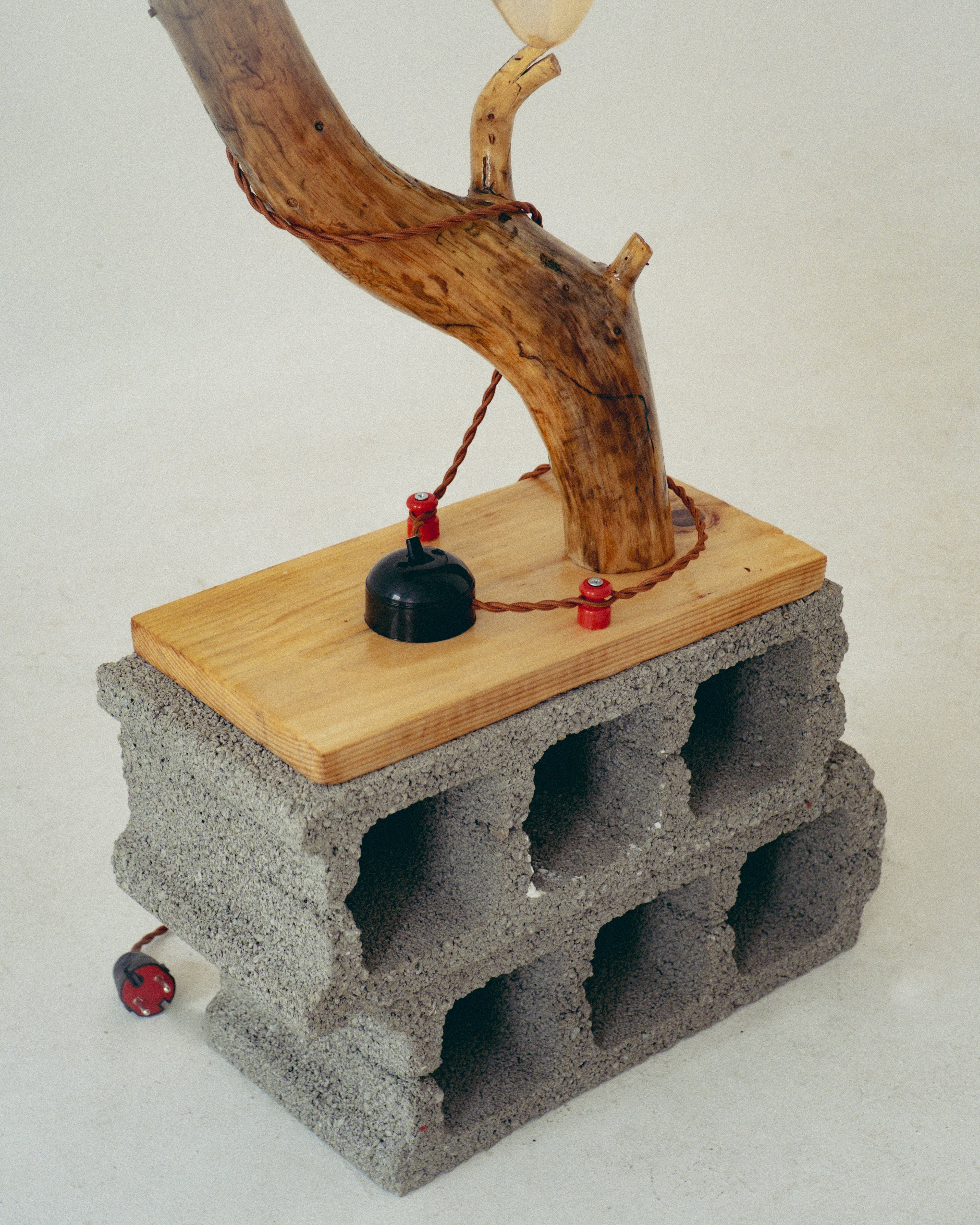 Lamp with wooden base and concrete block stand on a white background