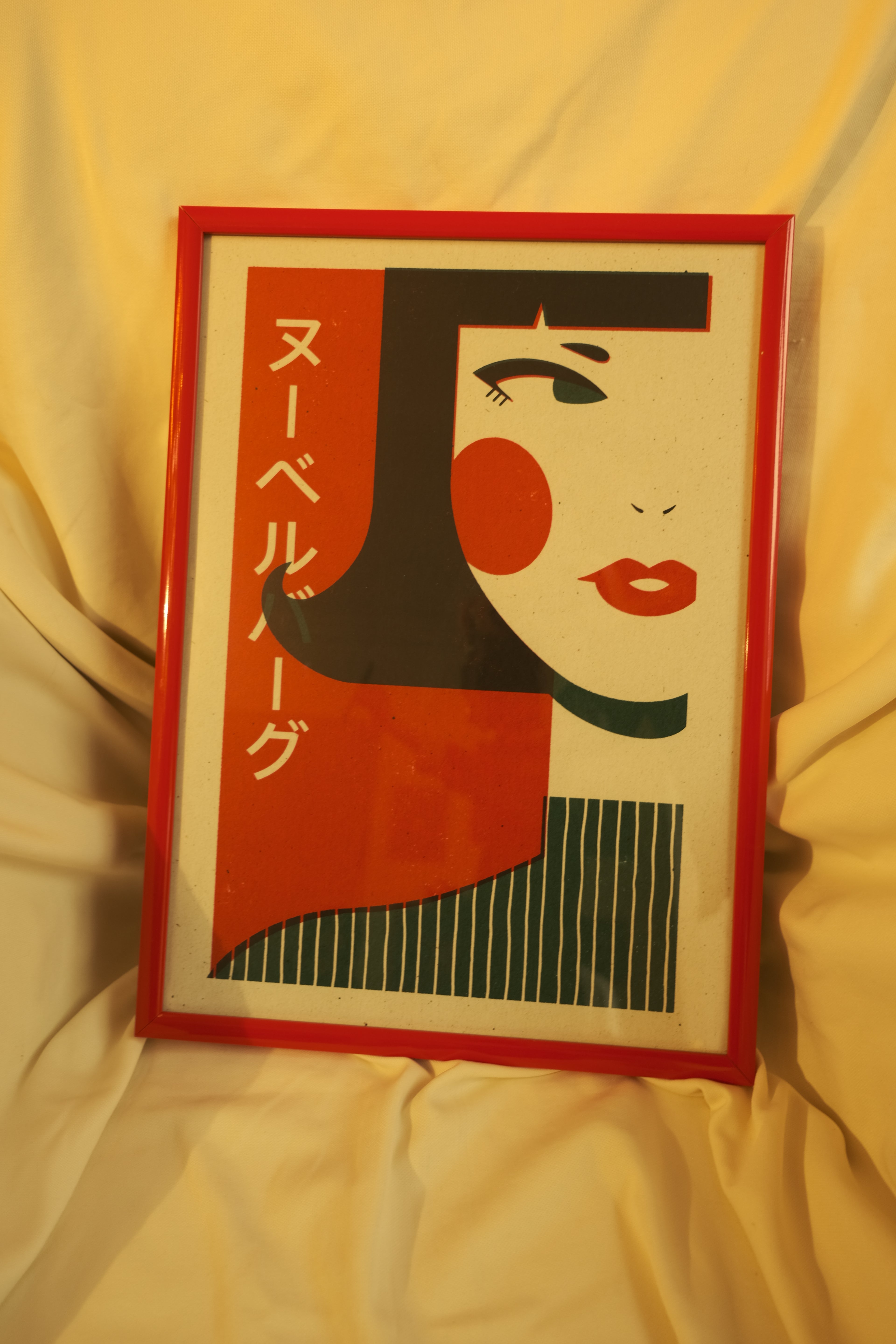 poster in chair with design of japanese girl, japanese words and red frame