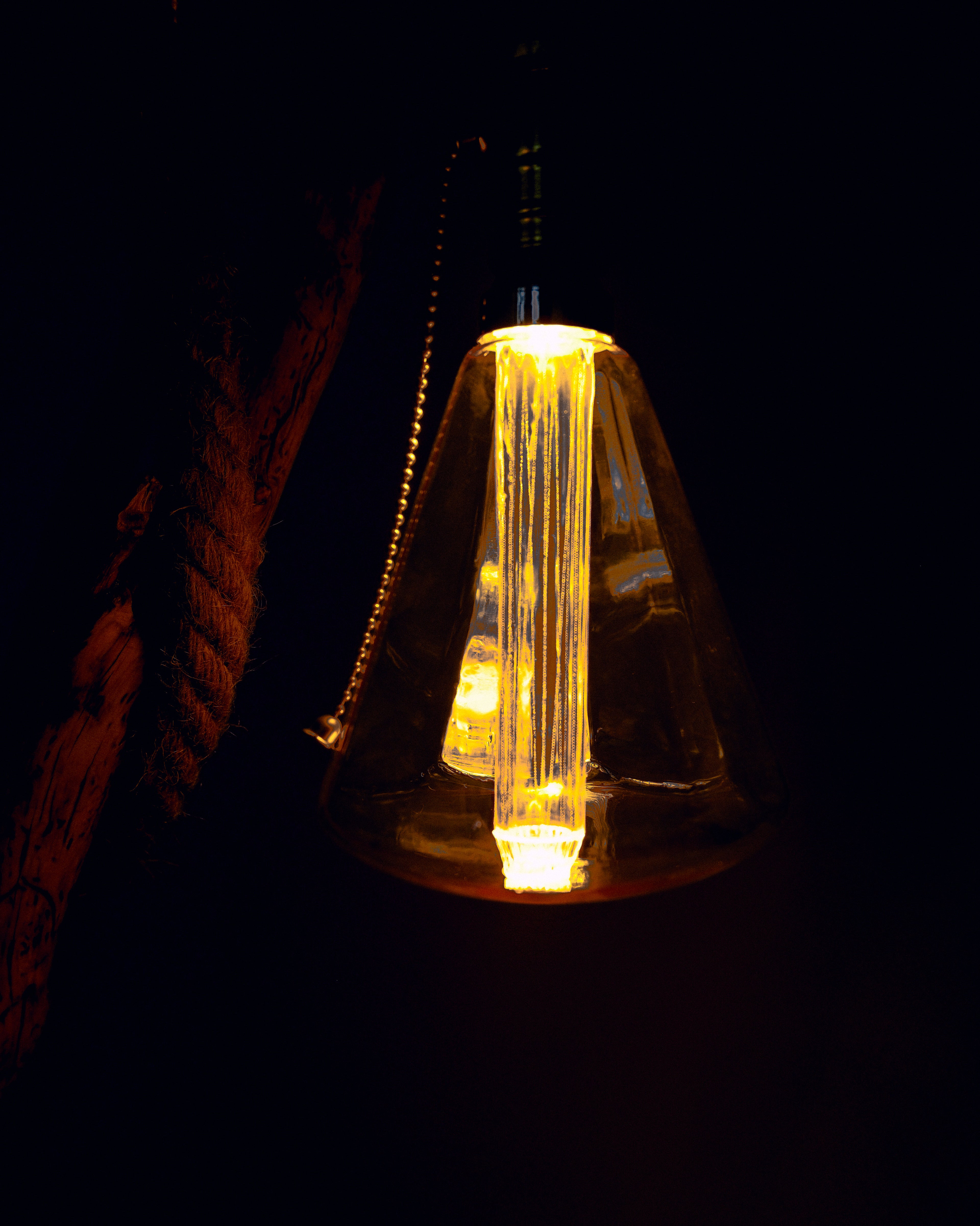 Decorative light bulb with a warm glow on a dark background