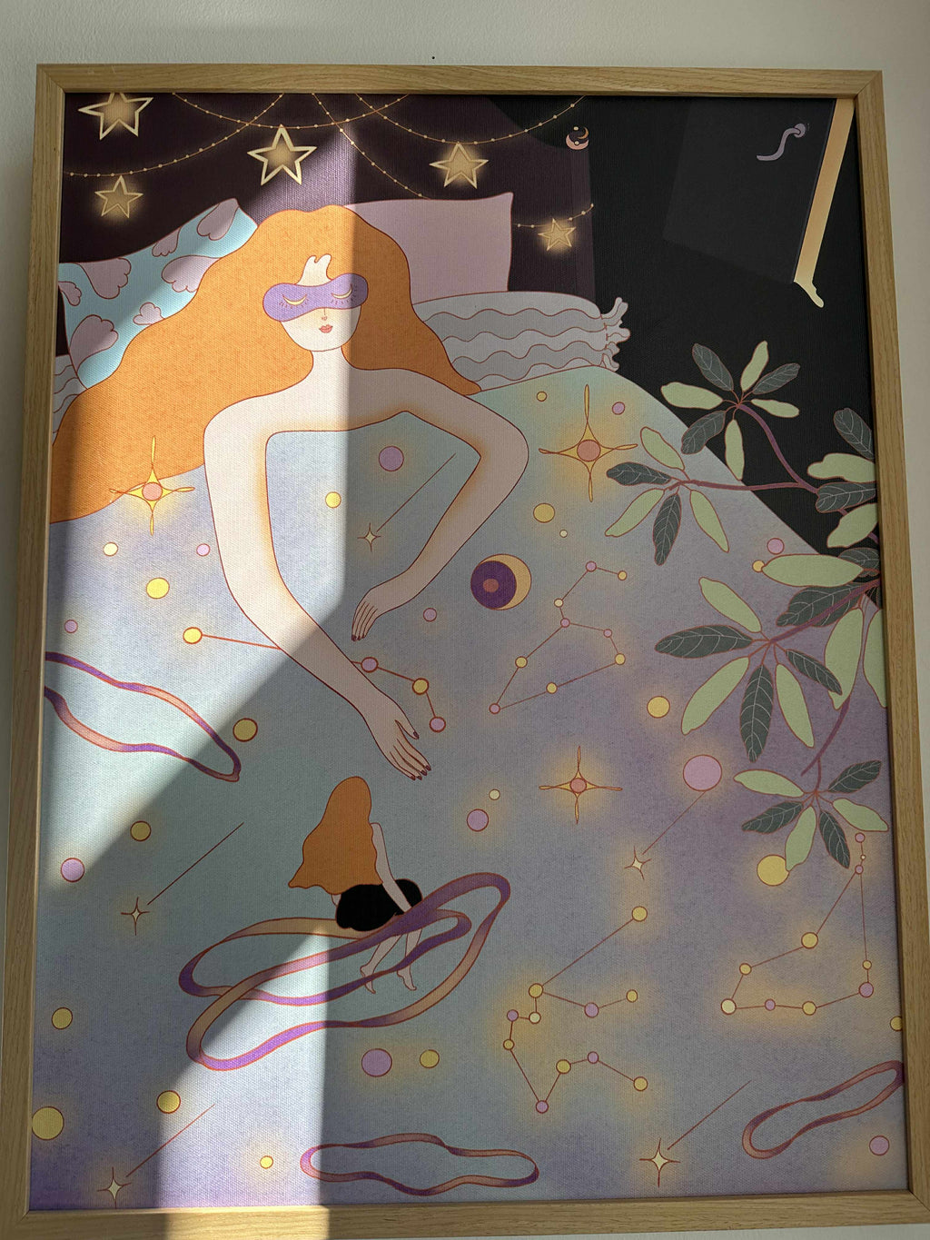 Illustration of a woman with blindfold sitting on a bed surrounded by stars and constellations.