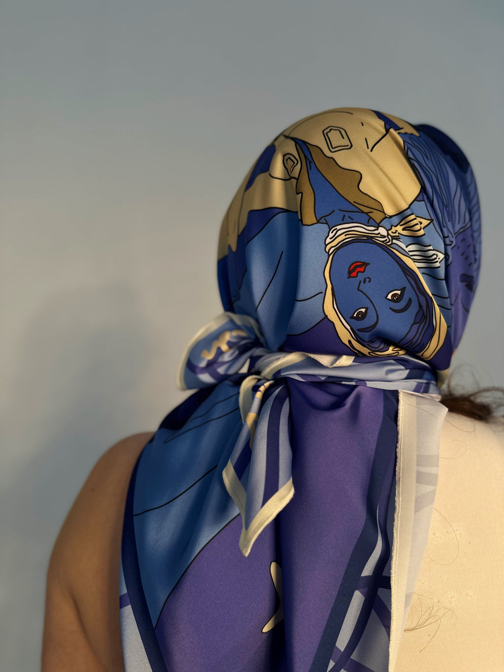 Model wearing Leo zodiac illustrated scarf with expressive color palette