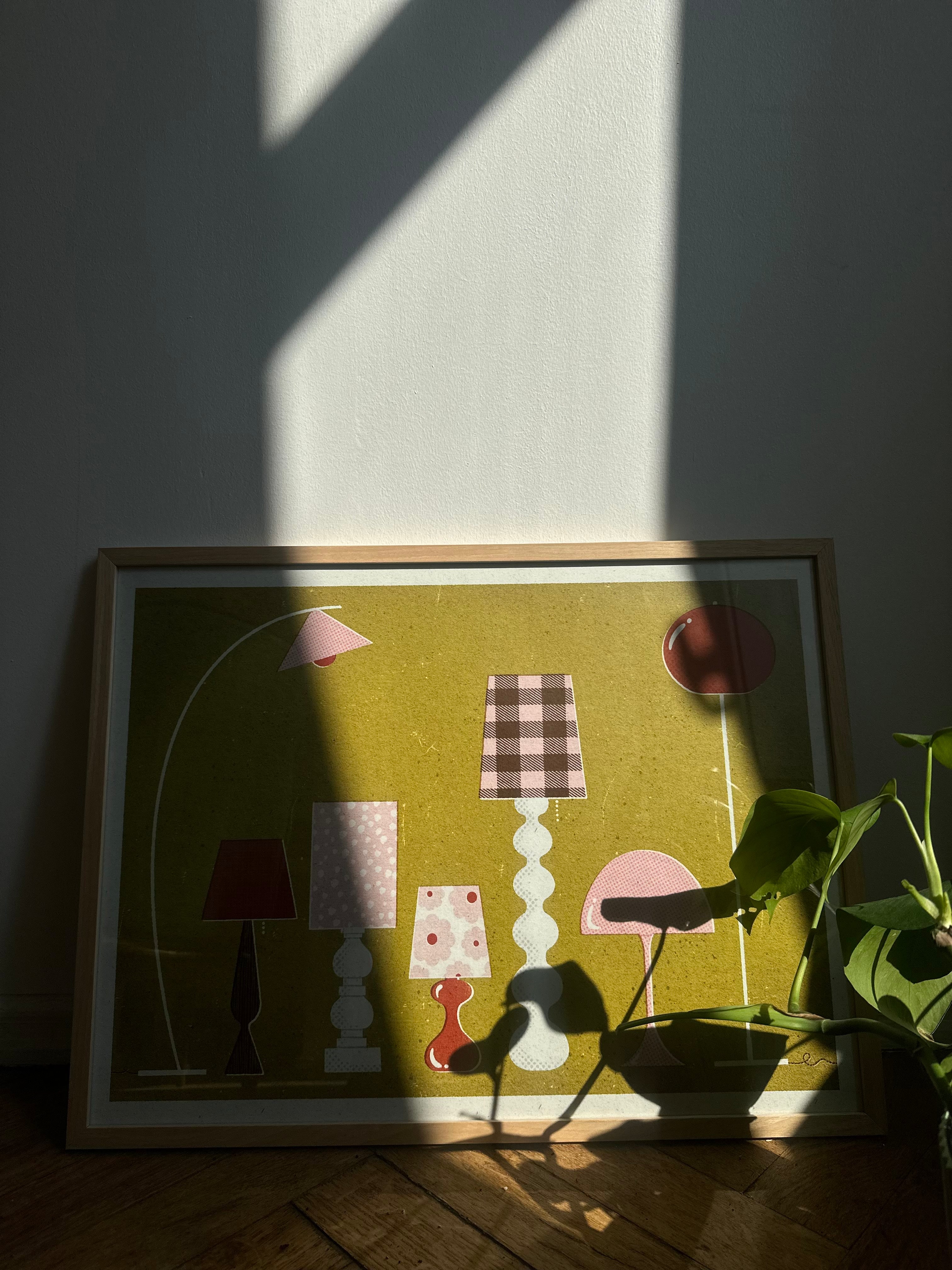 poster on the floor with design of lamps in mid century vibe and shadows on it