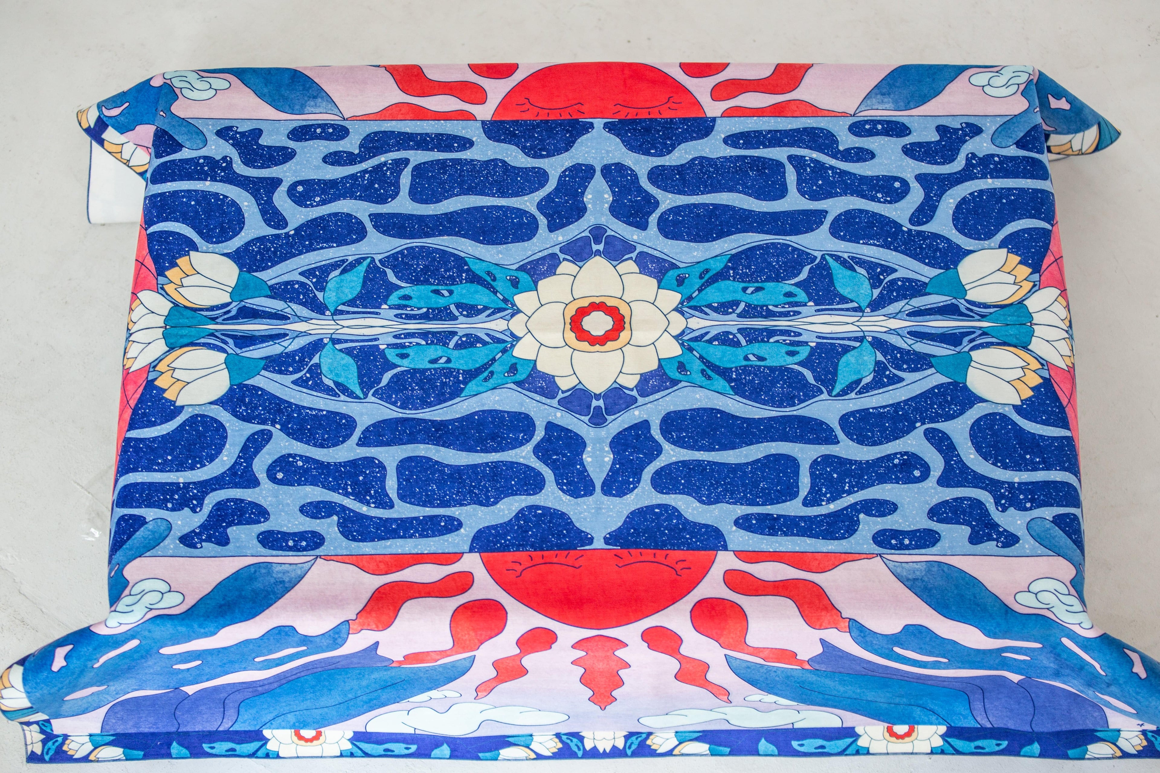 Blue and red “Moon” tablecloth on dining table – artwork by Anano Kevanishvili