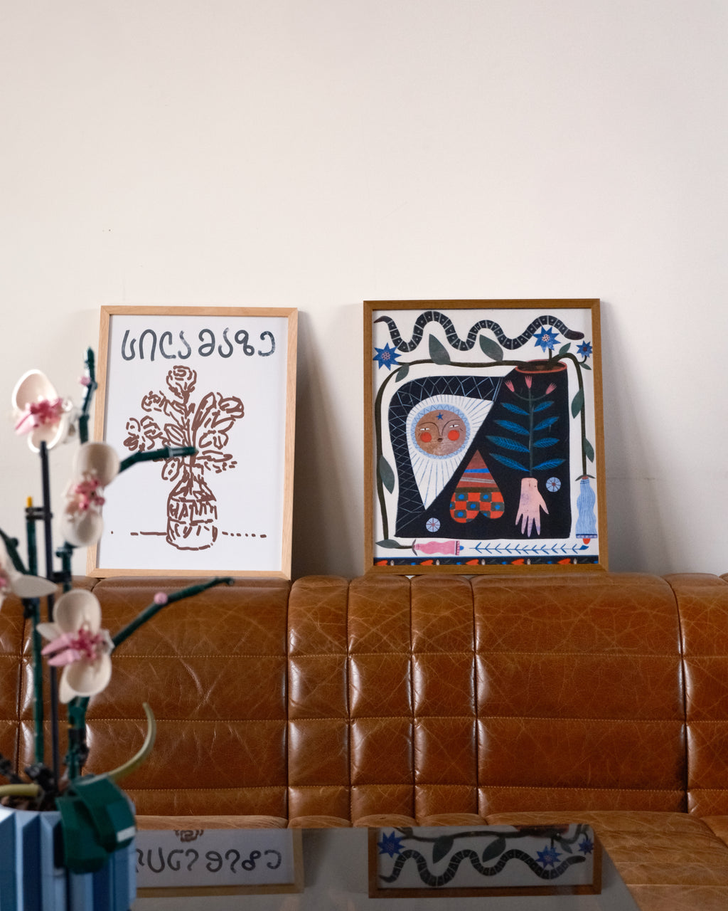 two posters next to each other in interior, posters by DAE
