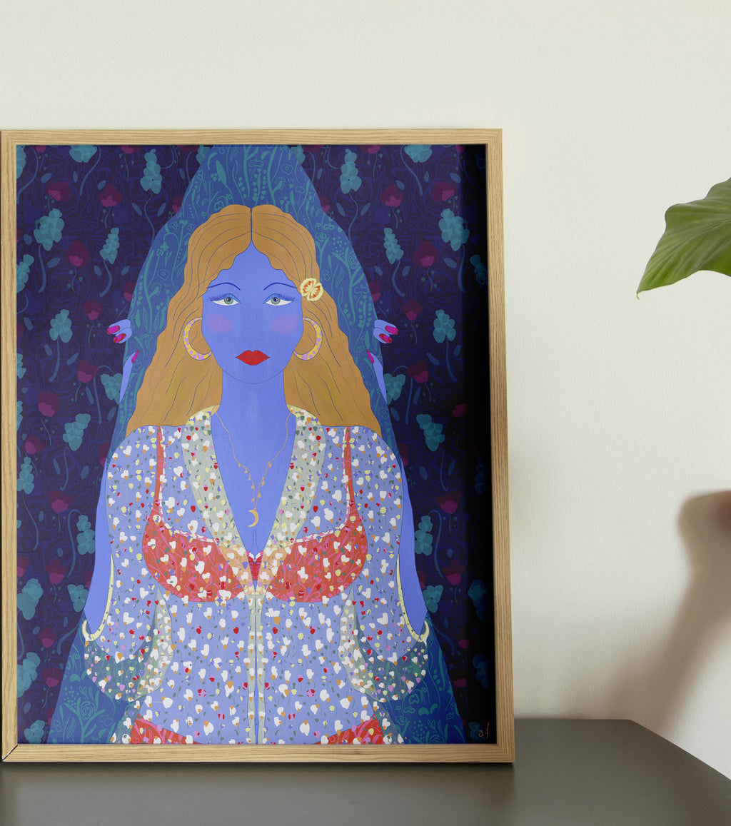 A framed poster of an illustration depicting a character with blue skin, dressed in a multicolored outfit, placed on a floor next to a chair, with natural light falling on it.