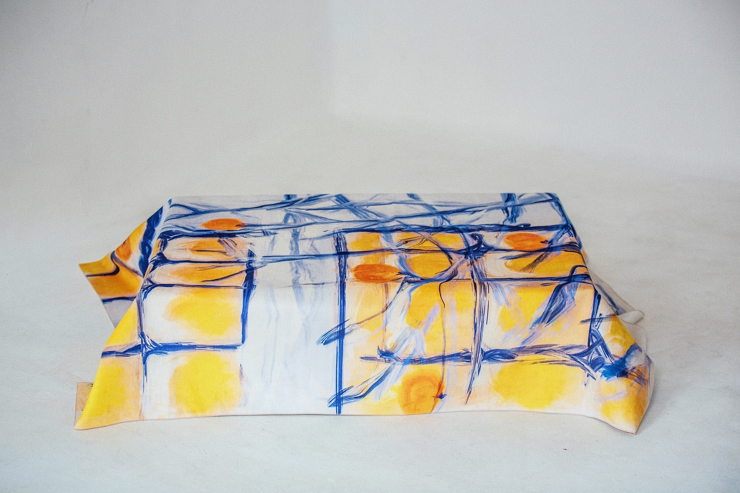 Persimmon tablecloth folded on a white background – orange and blue illustration by Anano Kevanishvili