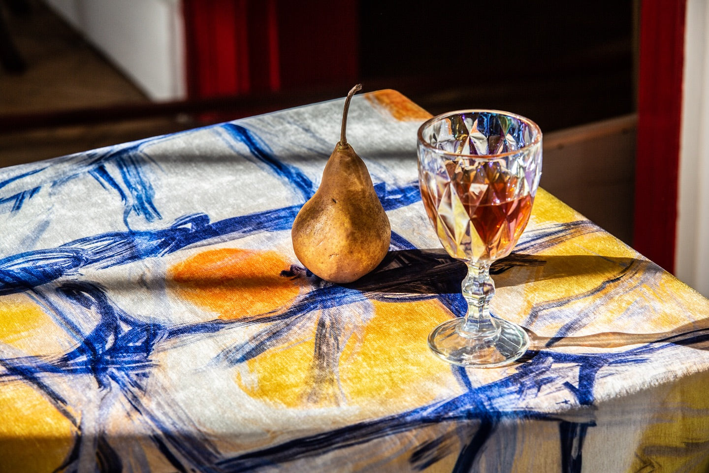 Close-up of Persimmon tablecloth showing detailed patterns and vibrant colors