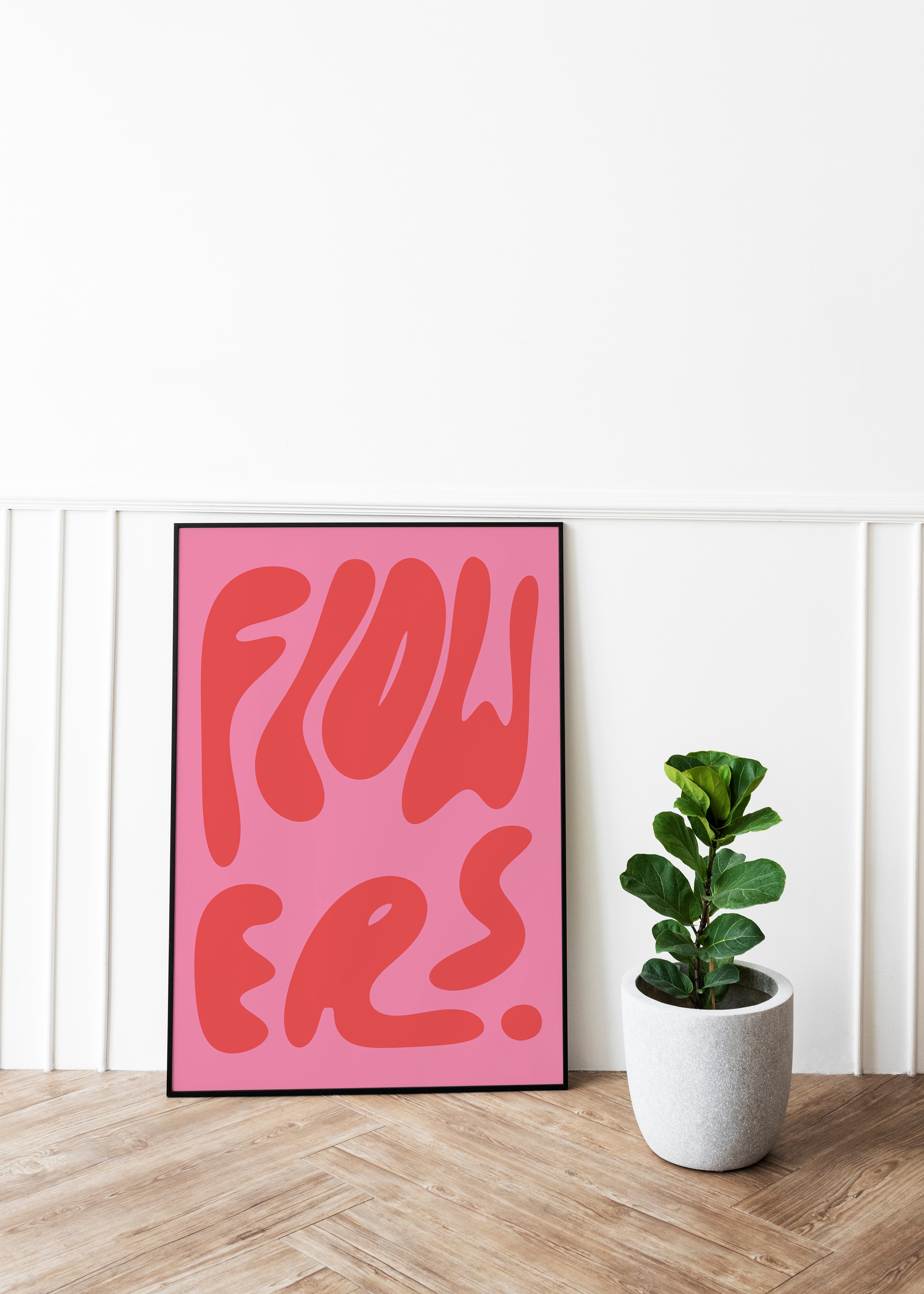 A framed poster with the word 'FLOWERS' by DAE in stylized lettering, predominantly in one color with a pink background.