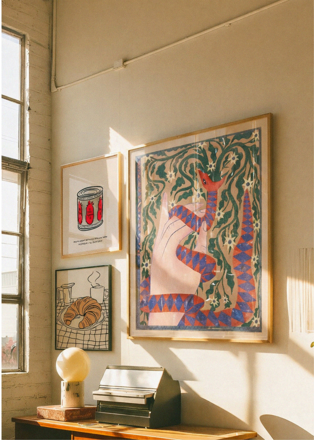 Artistic wall display with framed artwork in a home setting