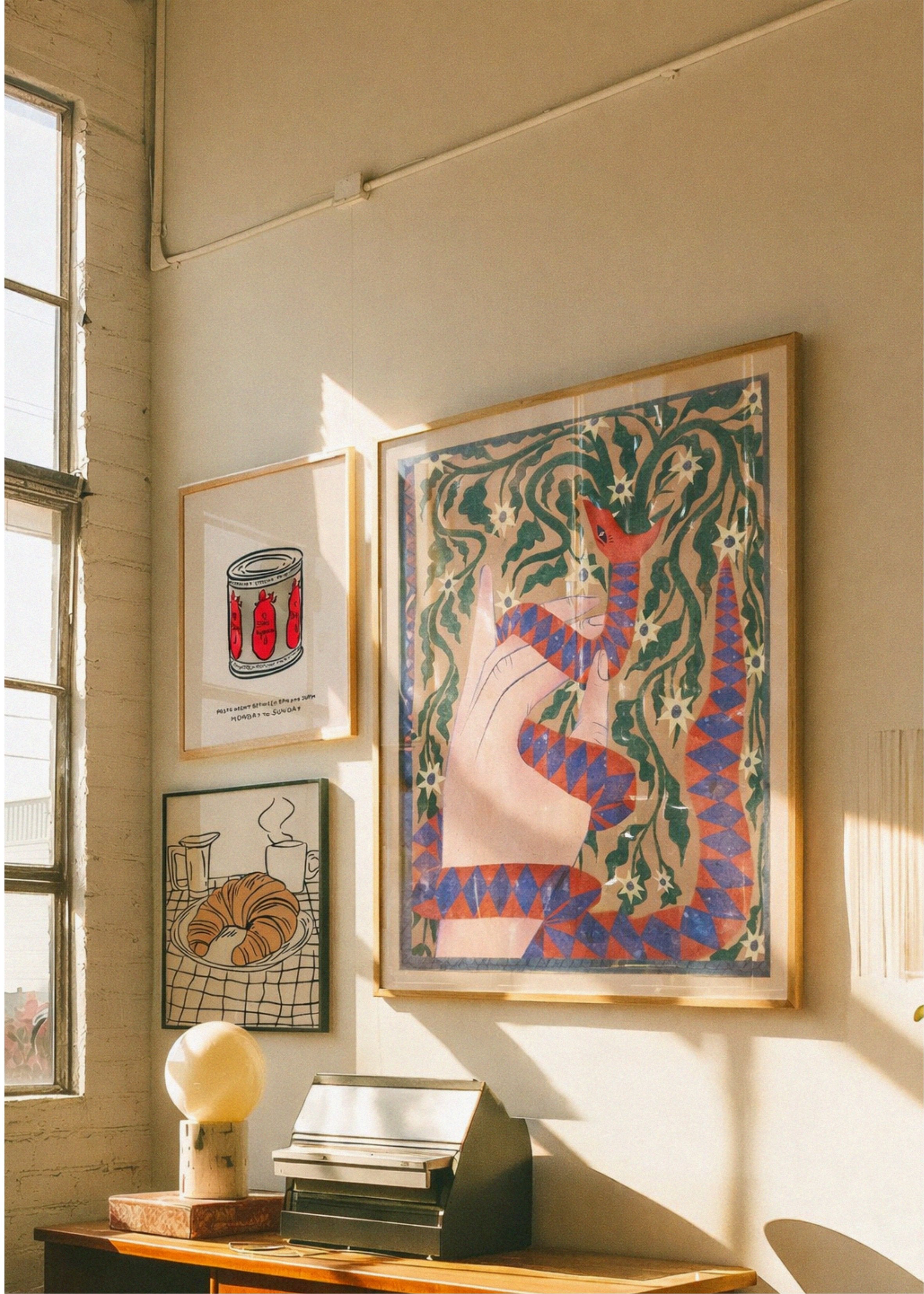 Artistic wall display with framed artwork in a home setting