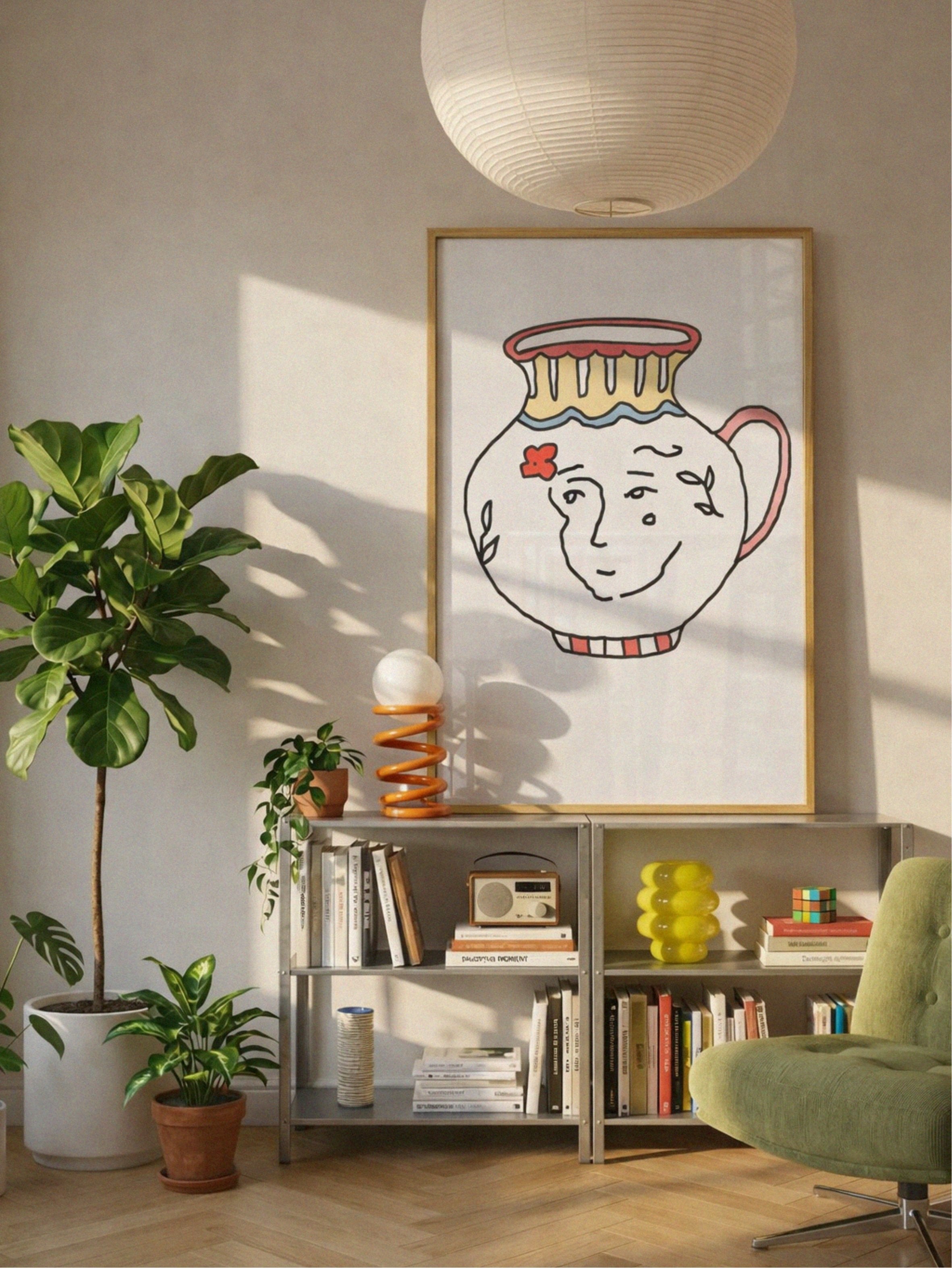 Living room with a colorful vase poster by DAE on the wall, bookshelf, and plants.
