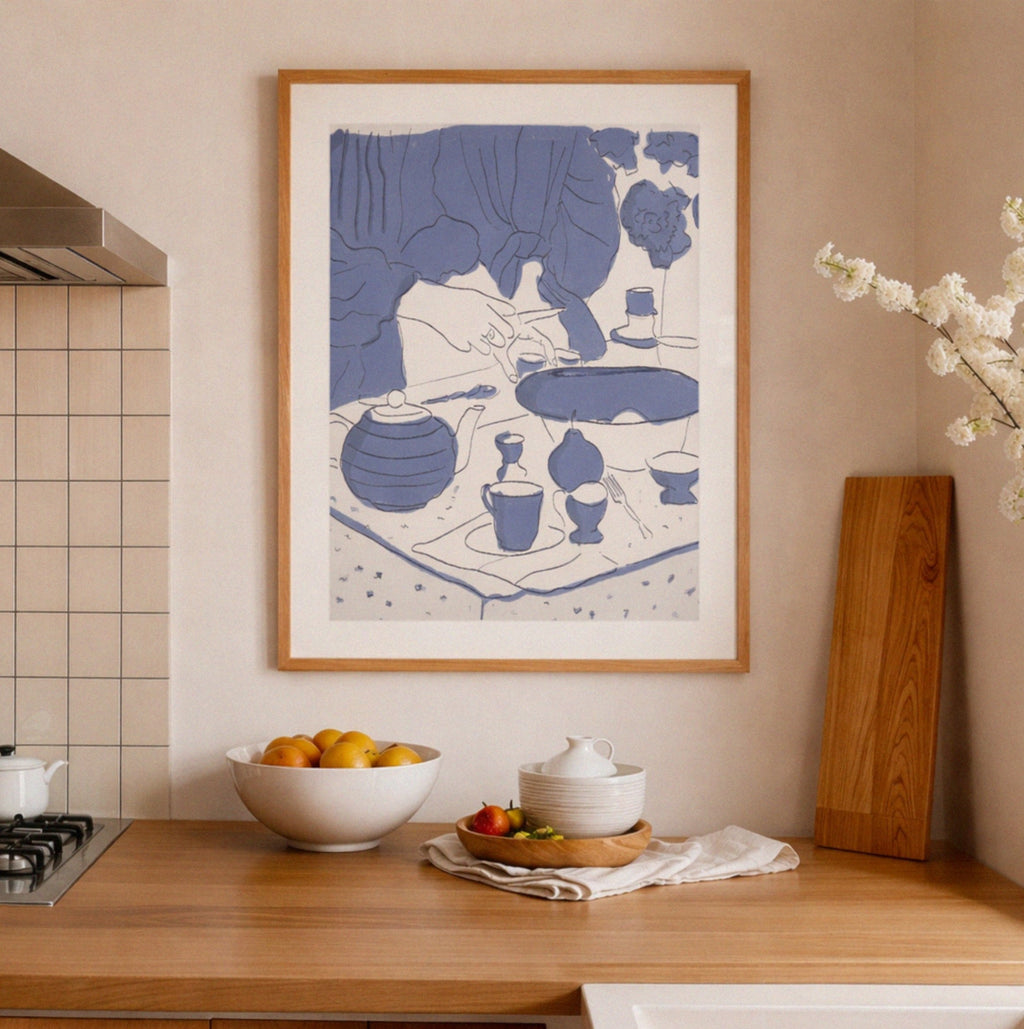 Framed artwork in a kitchen with a bowl of fruit and a cutting board.