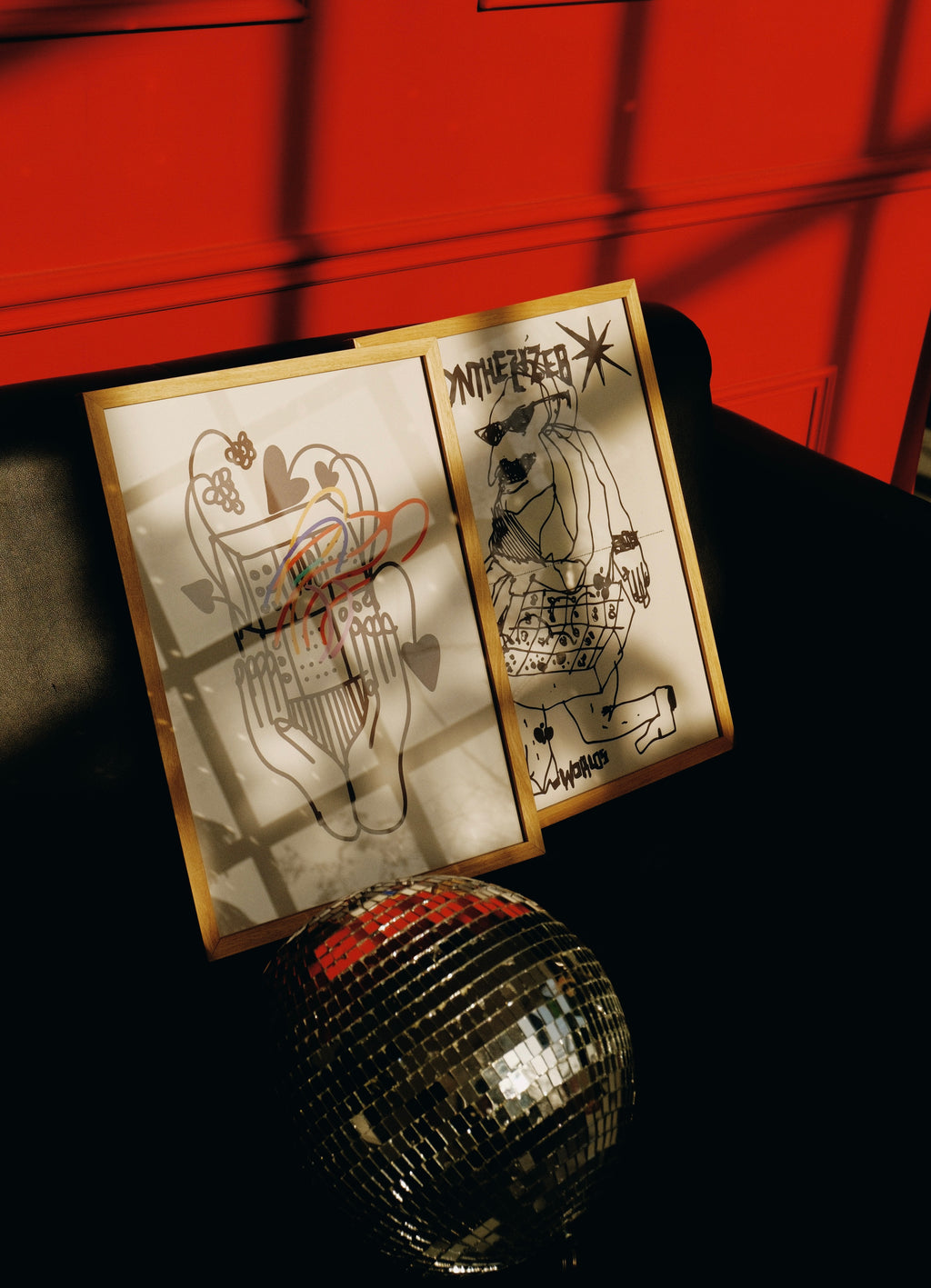 posters on the couch, with disco ball