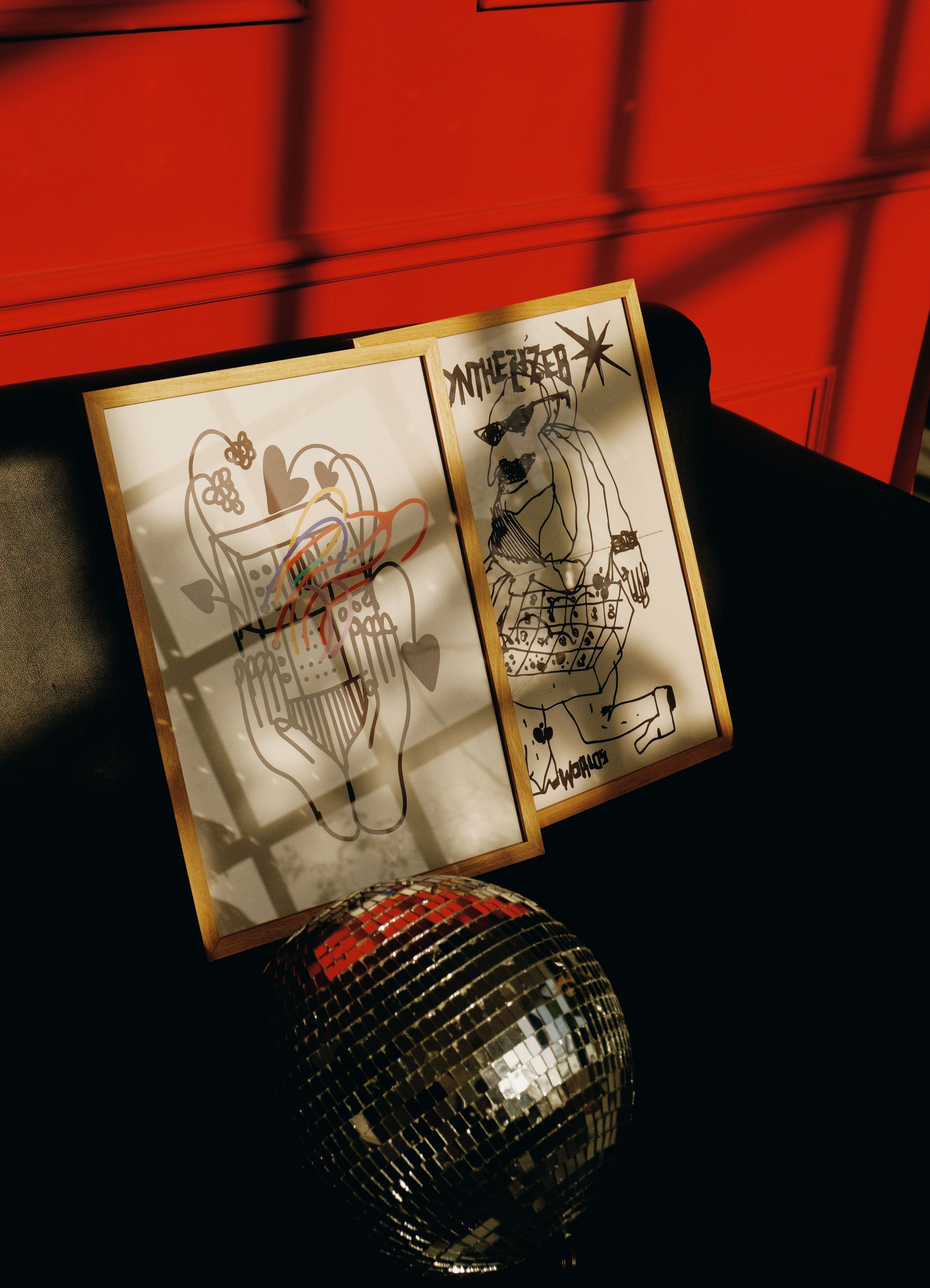 posters on the couch, with disco ball