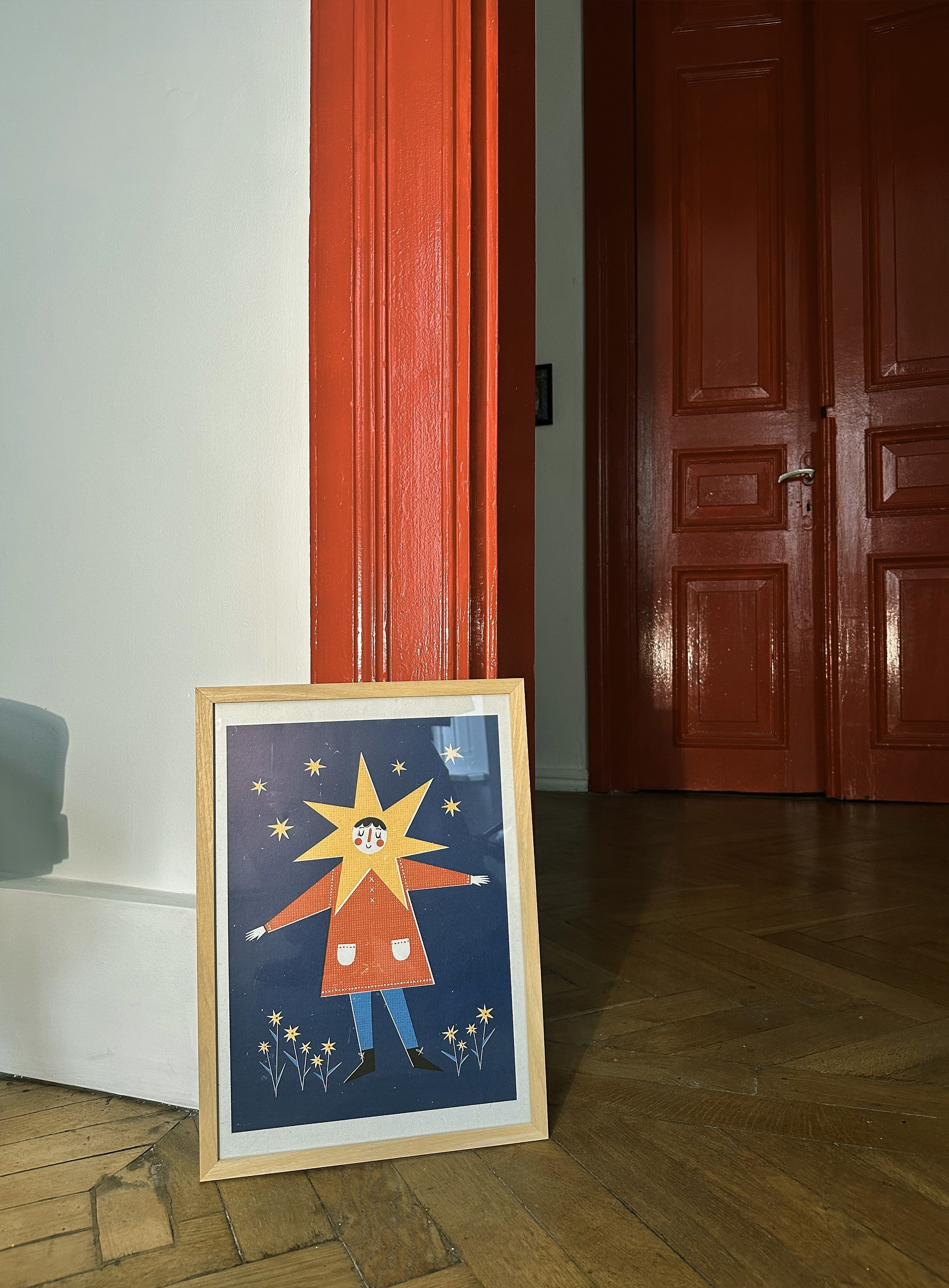 poster with stars and flowers on it, laying againt the wall