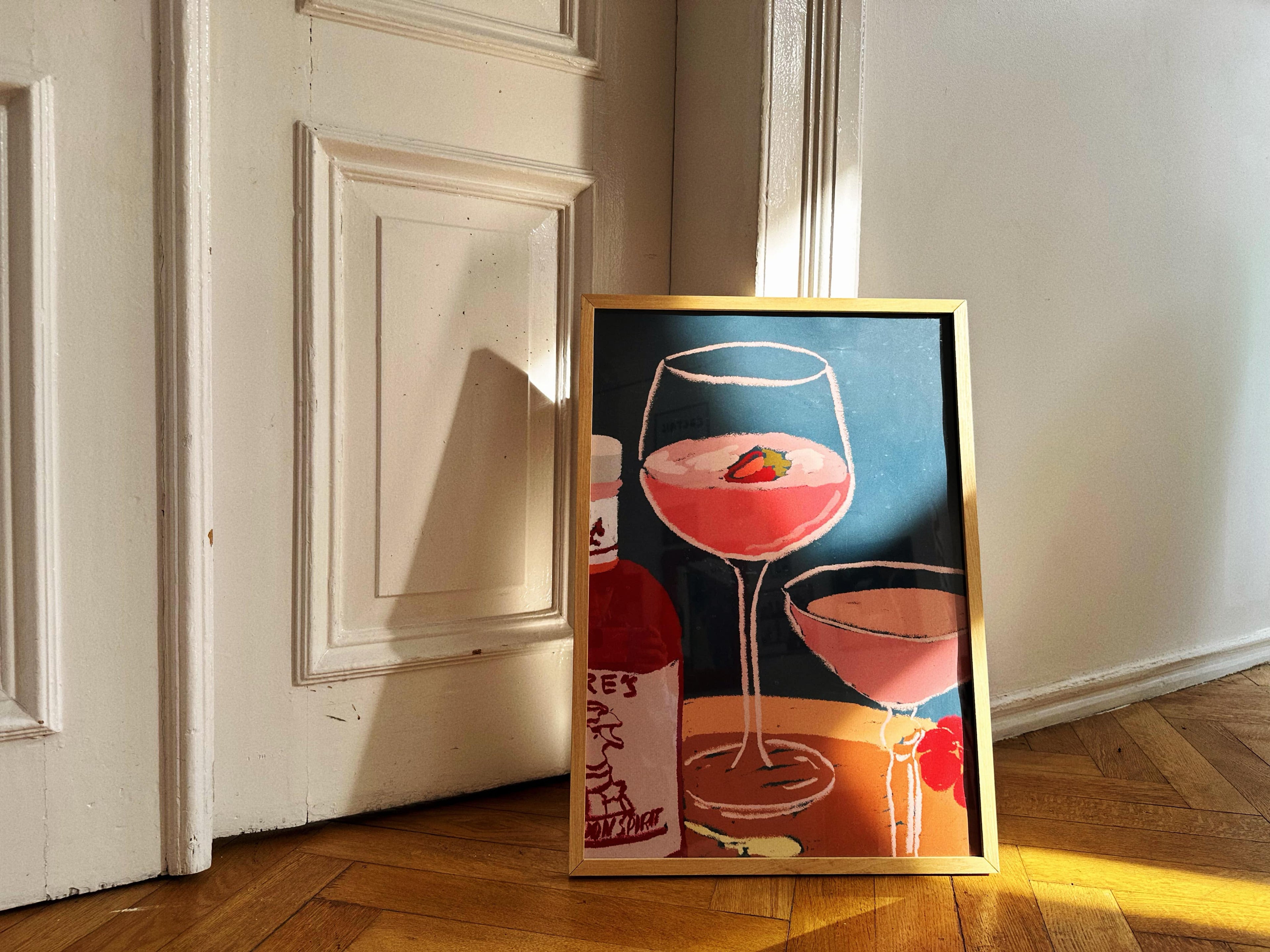 poster in interior with bottle and cocktail glasses
