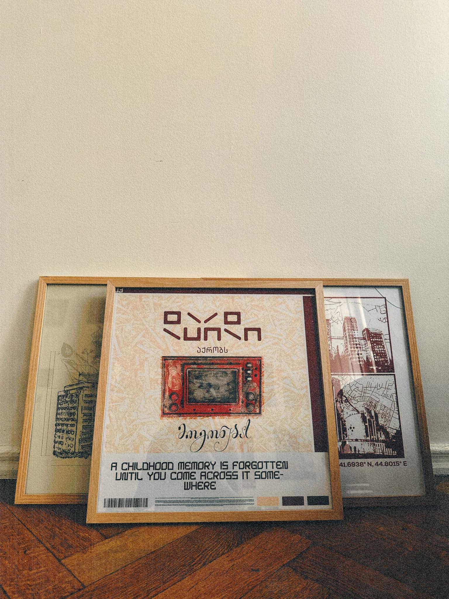 three posters from artist lasha lezhava x DAE in interior standing on floor