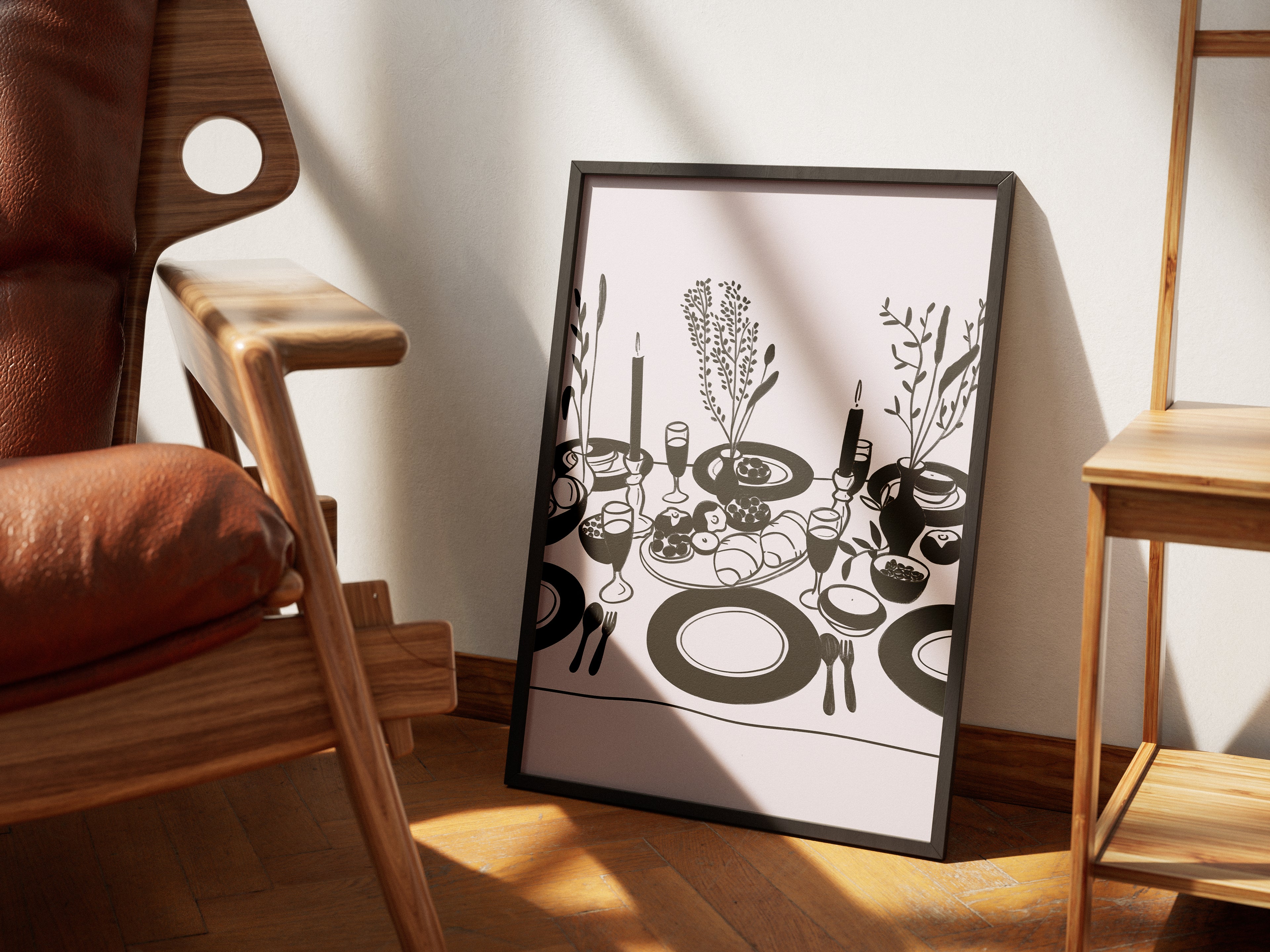A framed poster with a black and white illustration of a table setting, placed on the floor next to a chair, with a source of light casting a shadow on the wall.